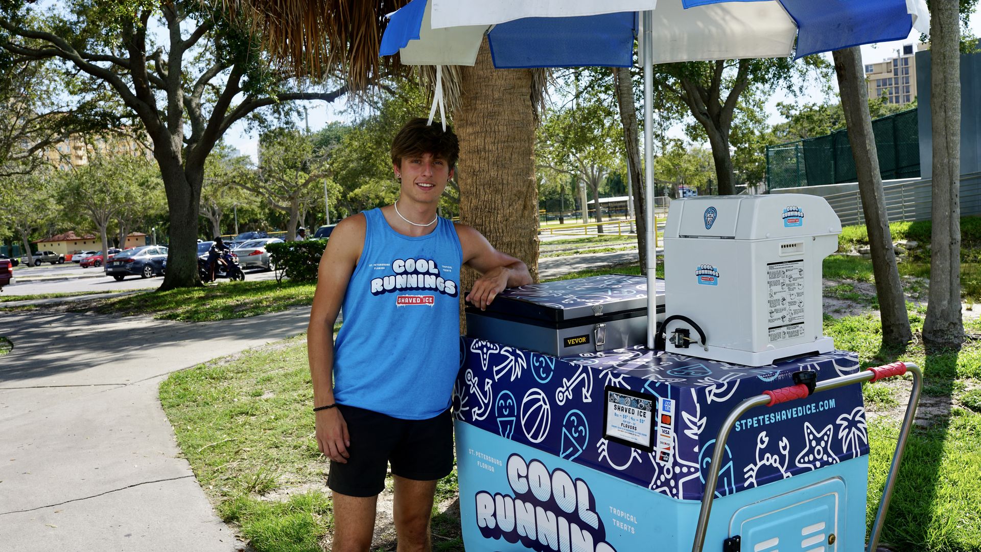 Aiden Leslie standing beside his "Cool Runnings" cart in St. Pete's North Shore Park.  