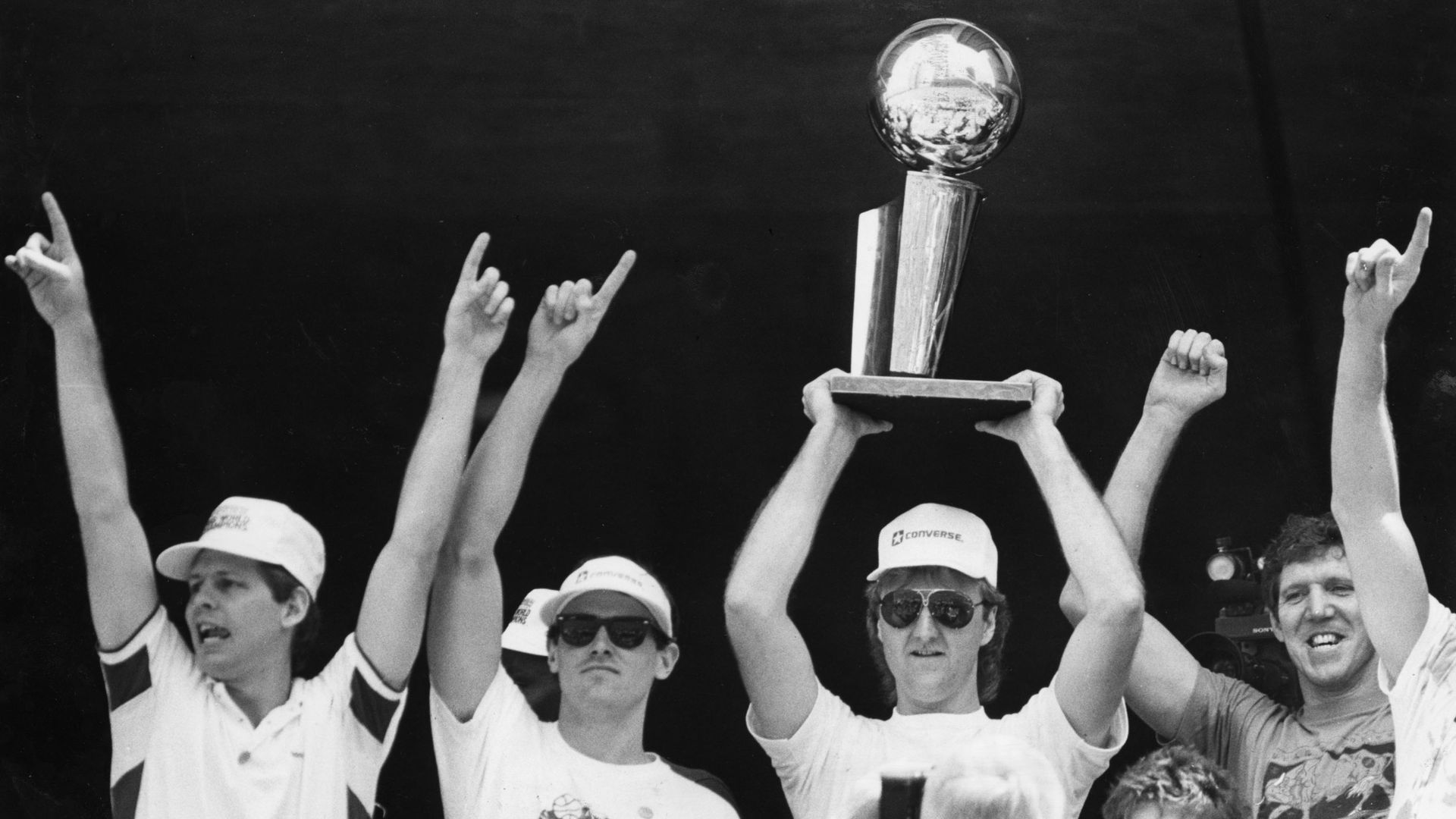 larry bird hoisting nba finals trophy