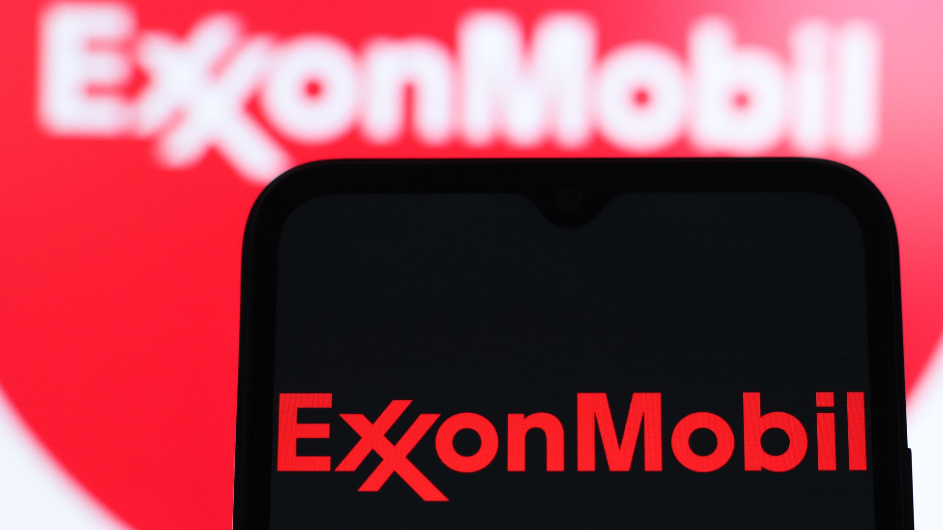  In this photo illustration, the Exxon Mobil Corporation logo is seen displayed on a smartphone screen. 