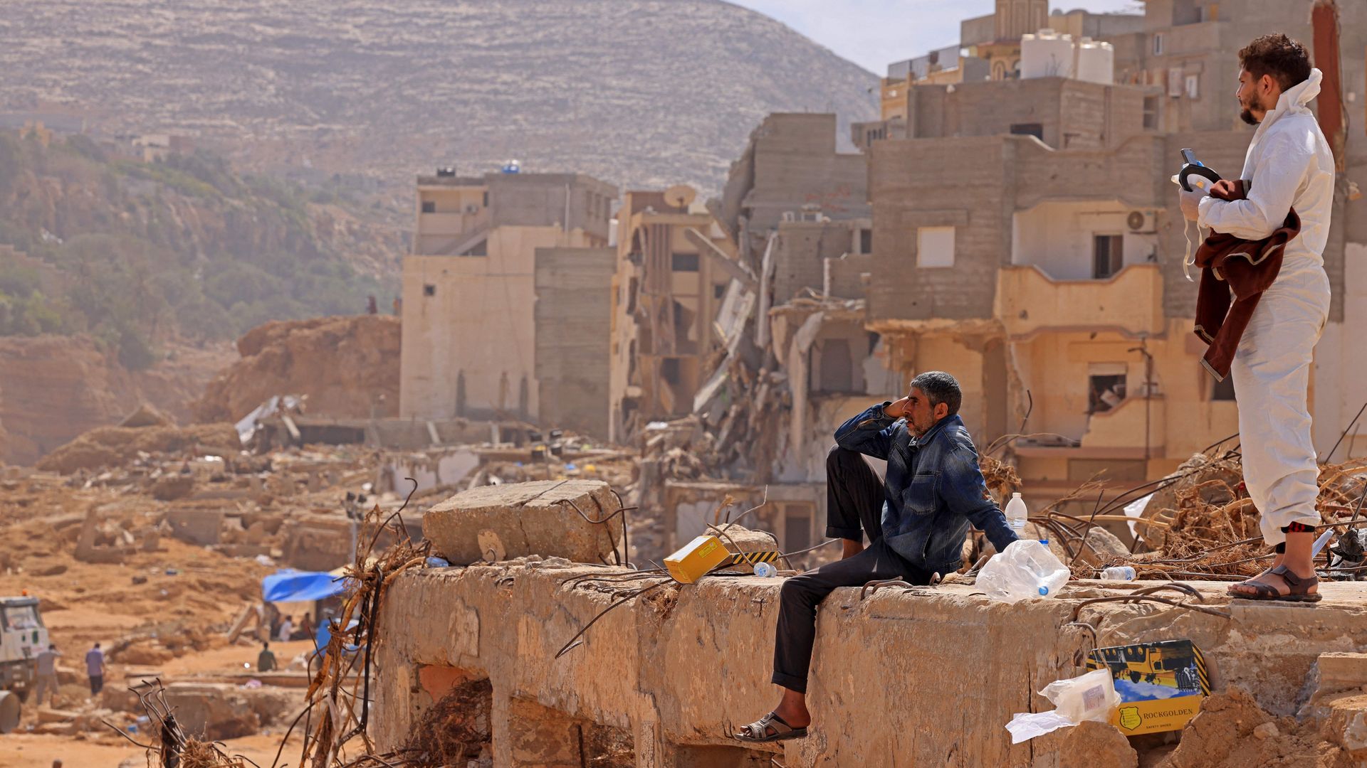 Two men gaze at the wreckage caused by a massive flood in Derna, Libya.