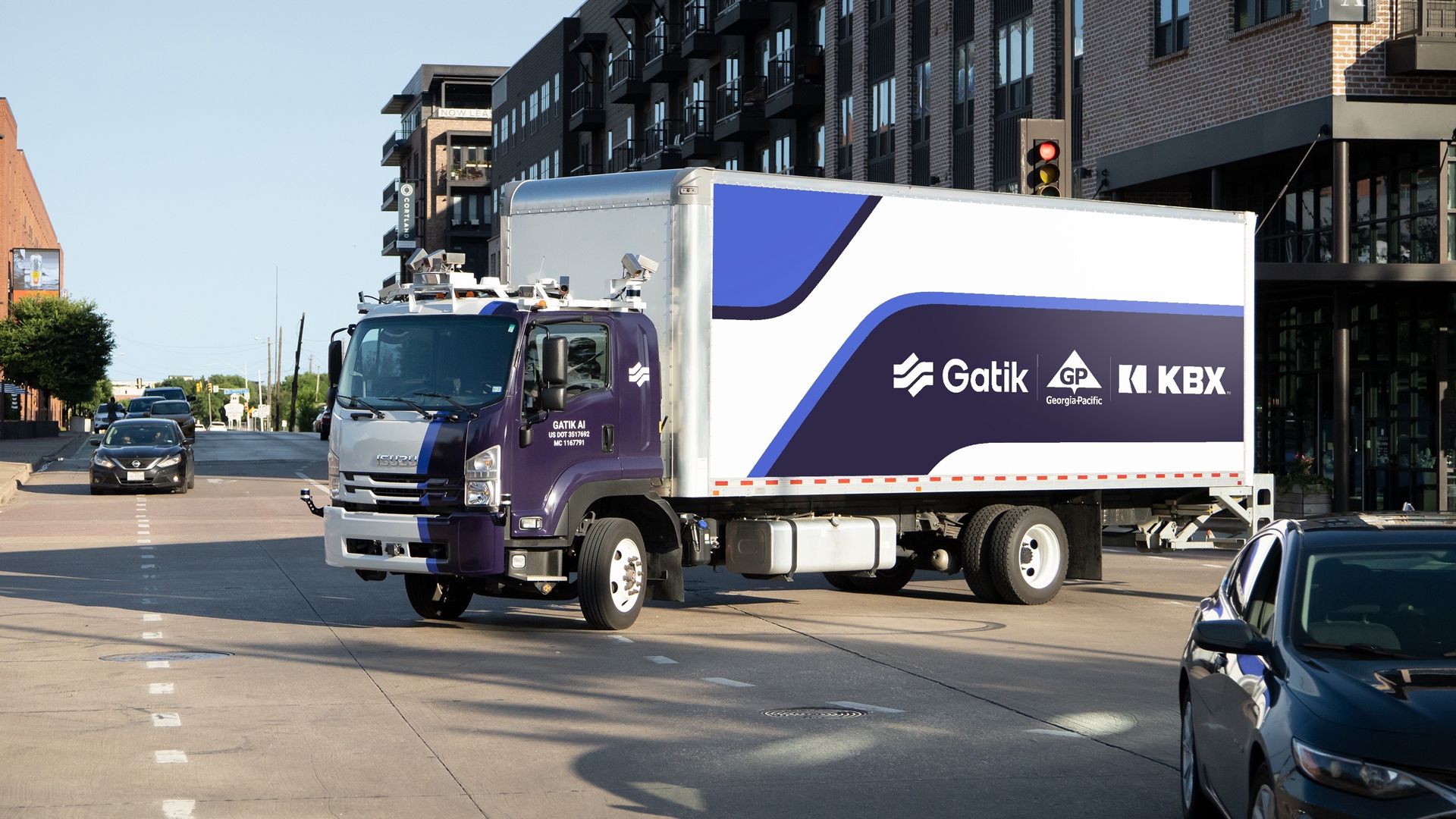 Tractor trailer with Gatik painted on its side.