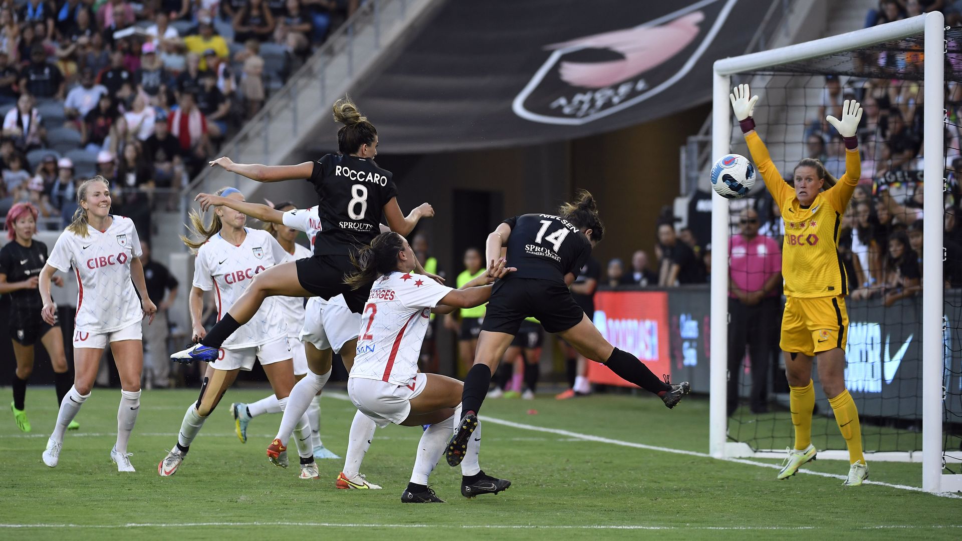 Cari Roccaro #8 of Angel City FC hits a header but goes wide of the goalkeeper Alyssa Naeher #1.
