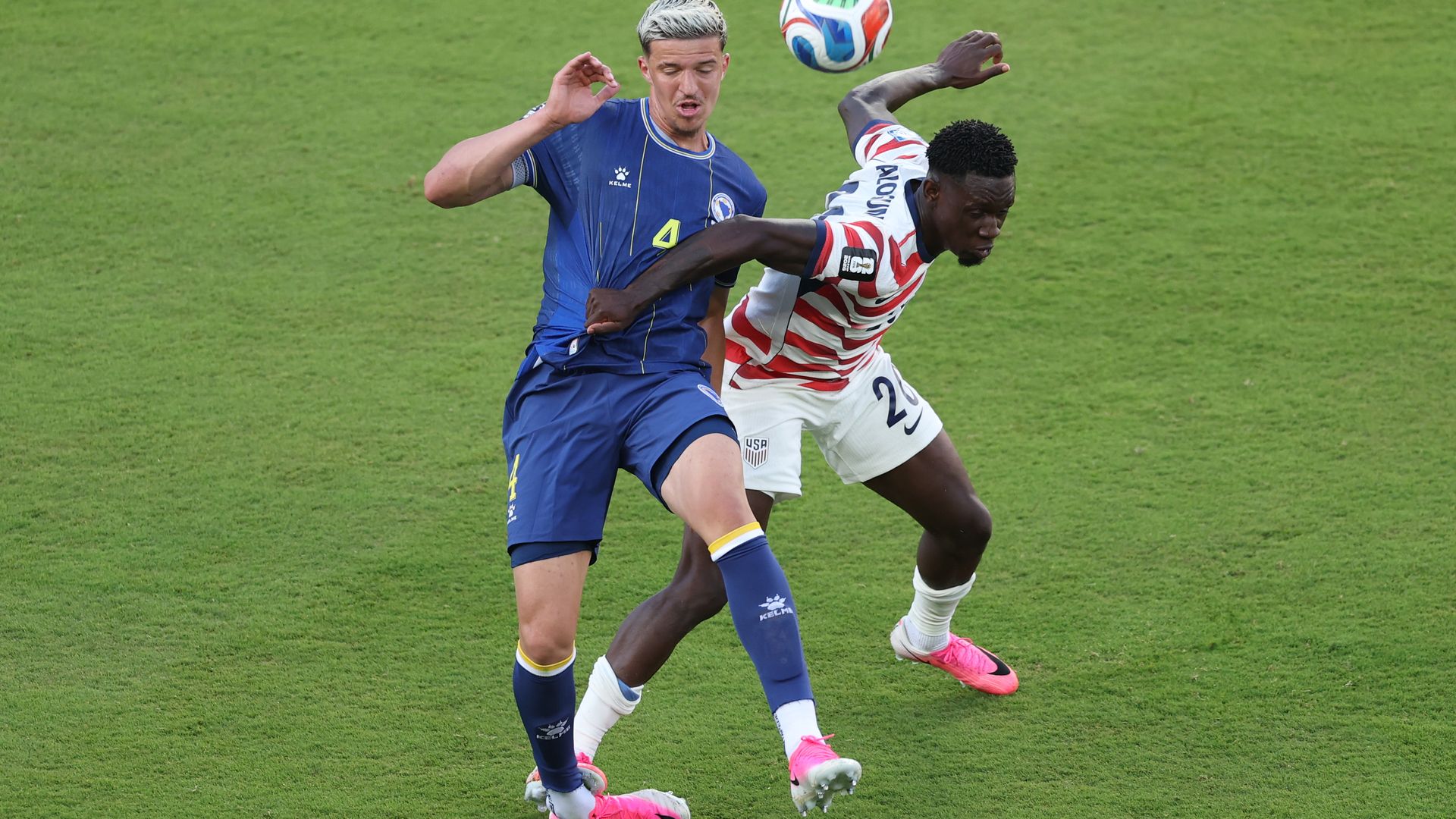 U.S. forward Folarin Balogun and Bosnia and Herzegovina defender Tarik Muharemović battle for the ball during a 2026 FIFA World Cup Round of 32 match in Santa Clara, California, moments before the challenge that led to Balogun's red card after a VAR review.