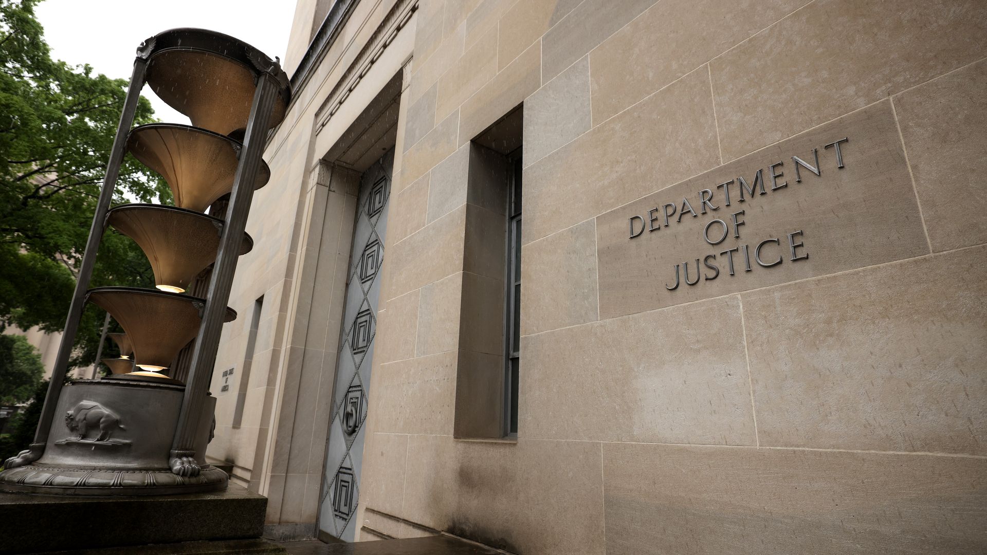 Photo of the exterior of the DOJ building, which has a sign with its name