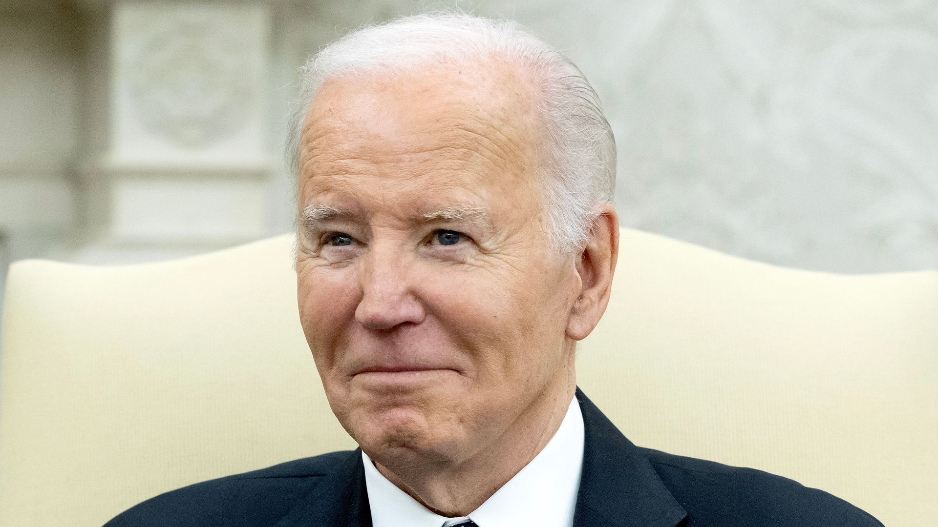 President Biden in a dark suit, shown from the shoulders up.