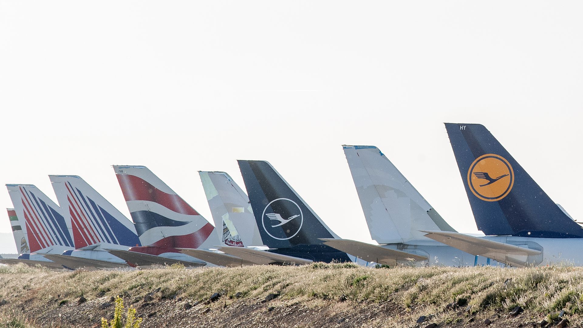 Passenger aircraft operated by Lufthansa, British Airways and Lufthansa stand parked in a storage facility in Spain