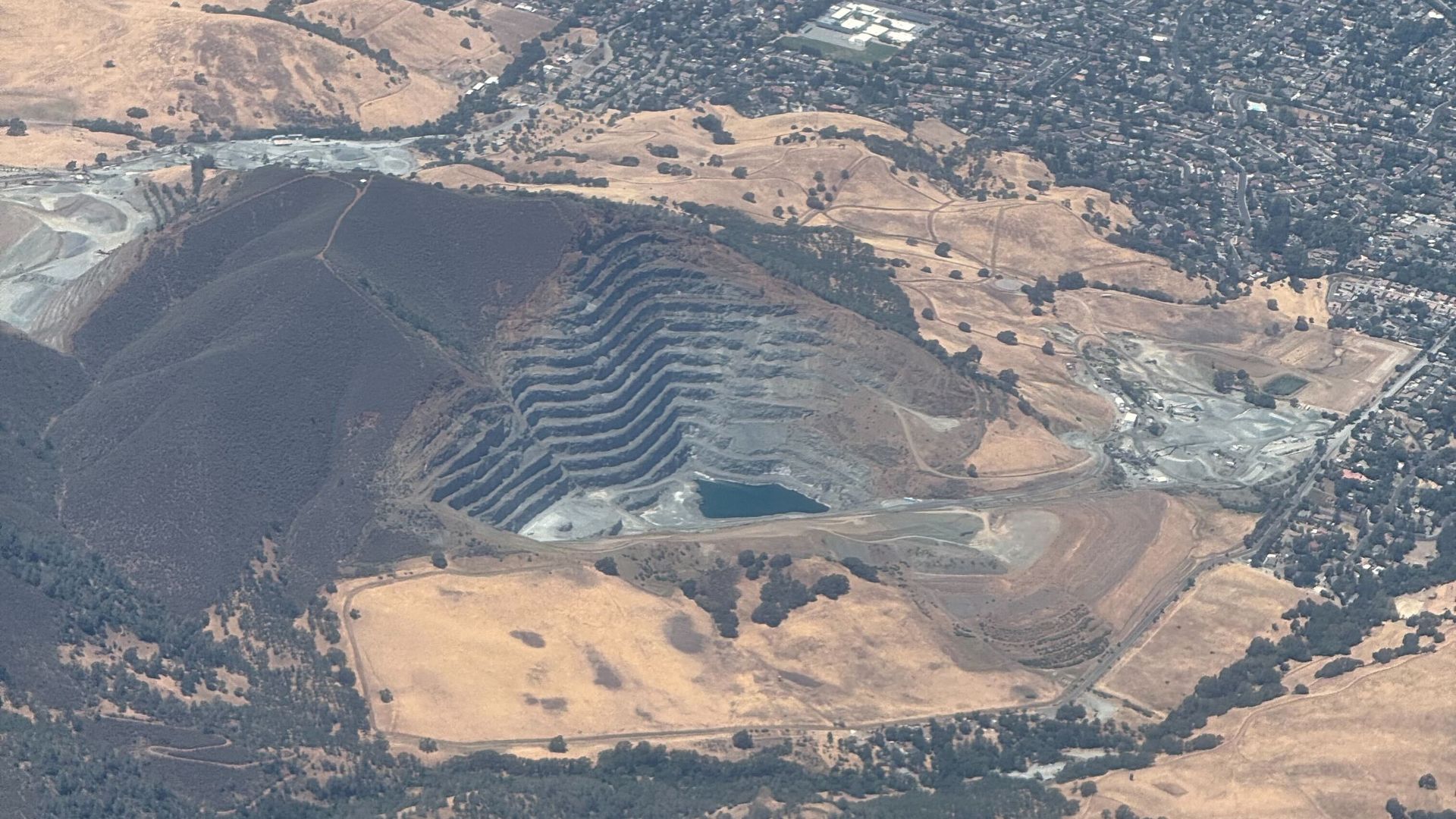 An aerial photo of a quarry, likely Lehigh Permanente Quarry in Cupertino, California/