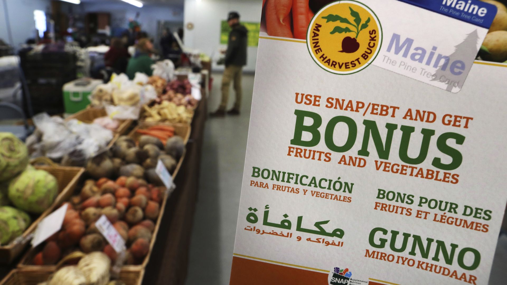 Sign promoting a bonus when SNAP used in grocery store. 