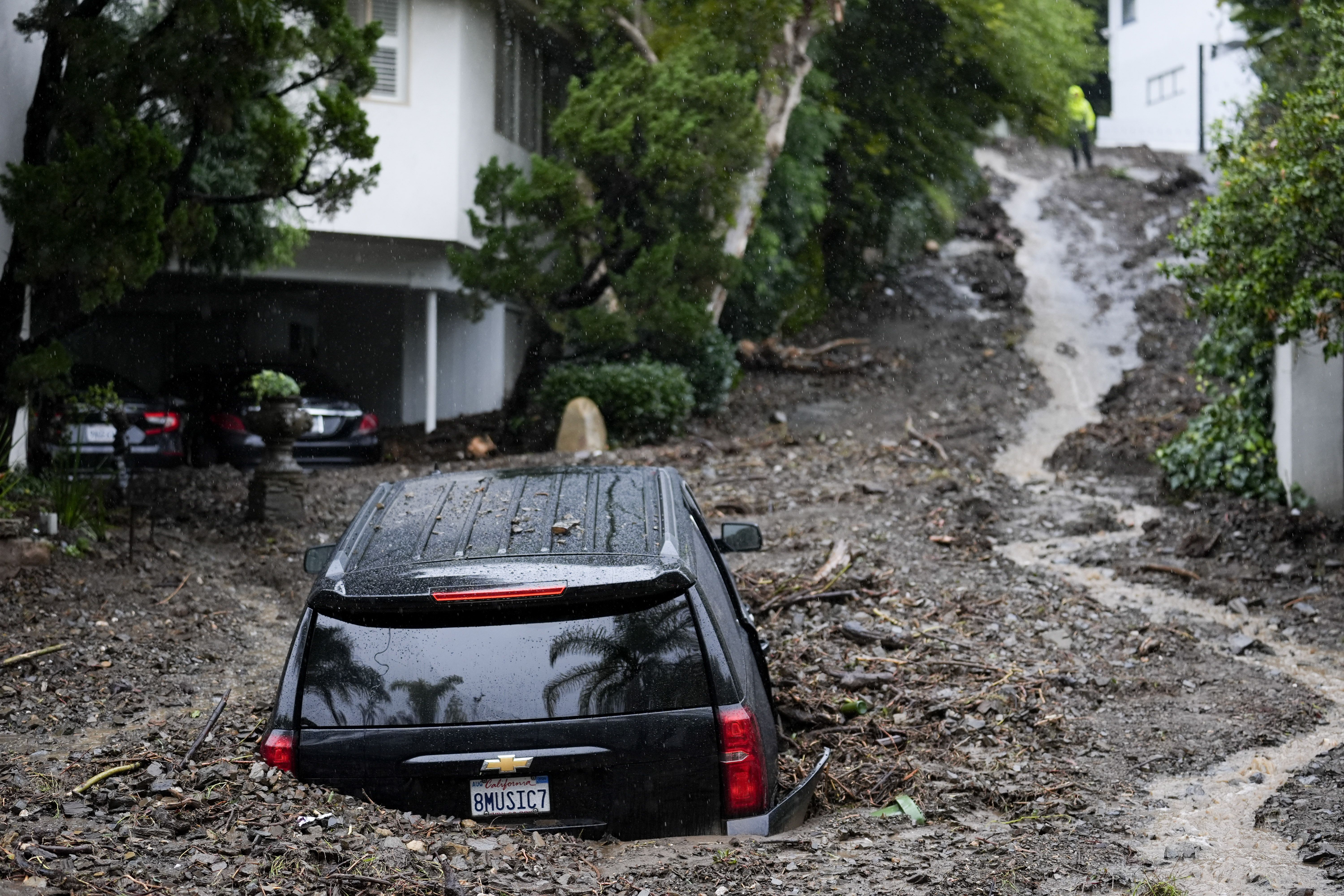 An SUV is buried by a mudslide yesterday in the Beverly Crest area of L.A.