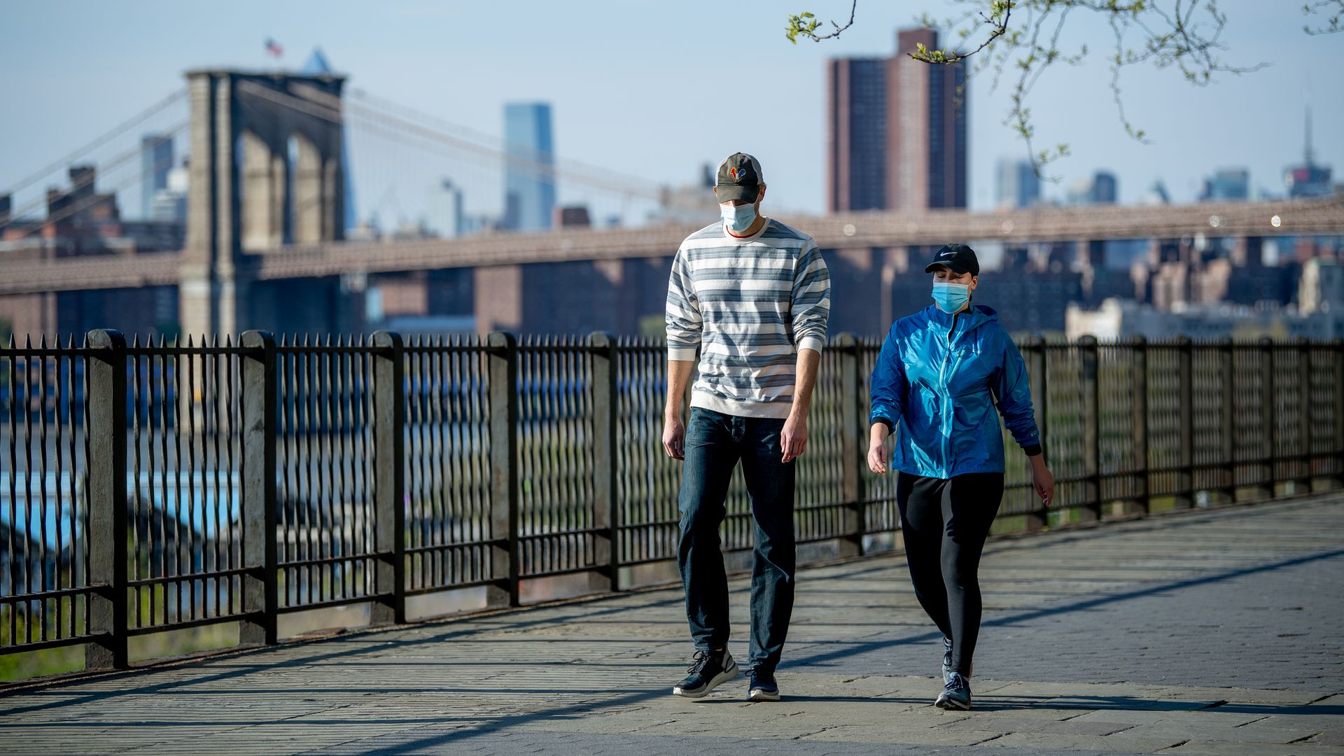Two people with the brroklyn bridge in the background 
