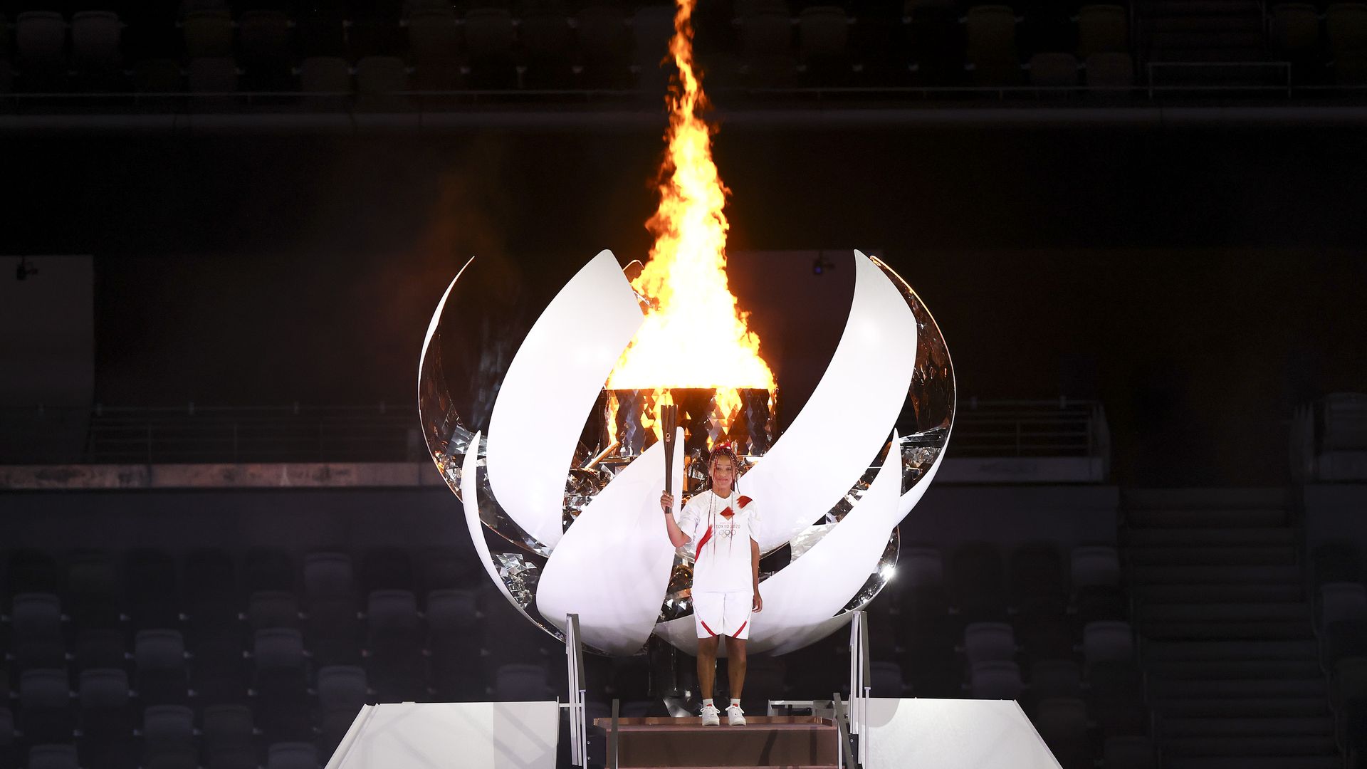 Naomi Osaka lights the Olympic cauldron. Photo: Clive Rose/Getty Images