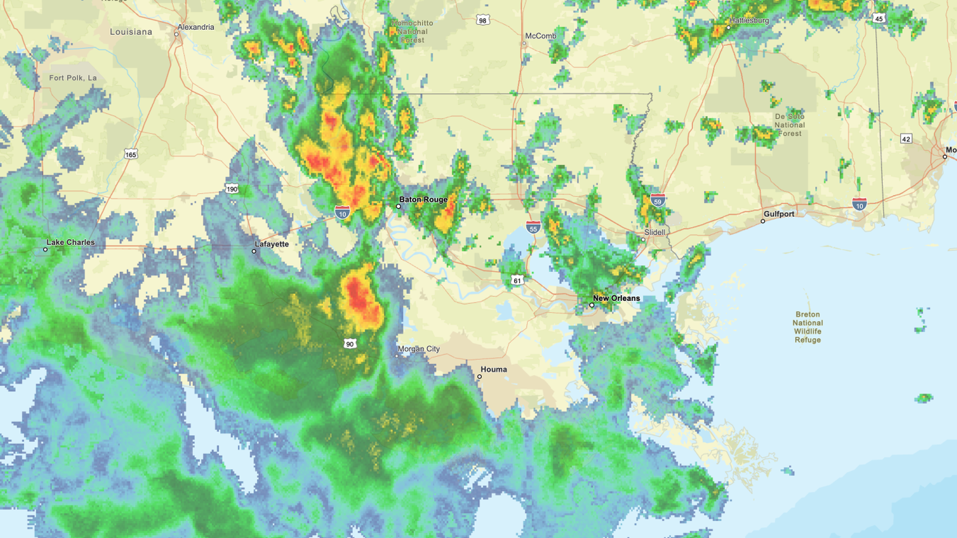 Radar weather map showing heavy rain and storms in red and yellow near Baton Rouge and surrounding areas in Louisiana, with lighter rain in green and blue spreading across the Gulf Coast.