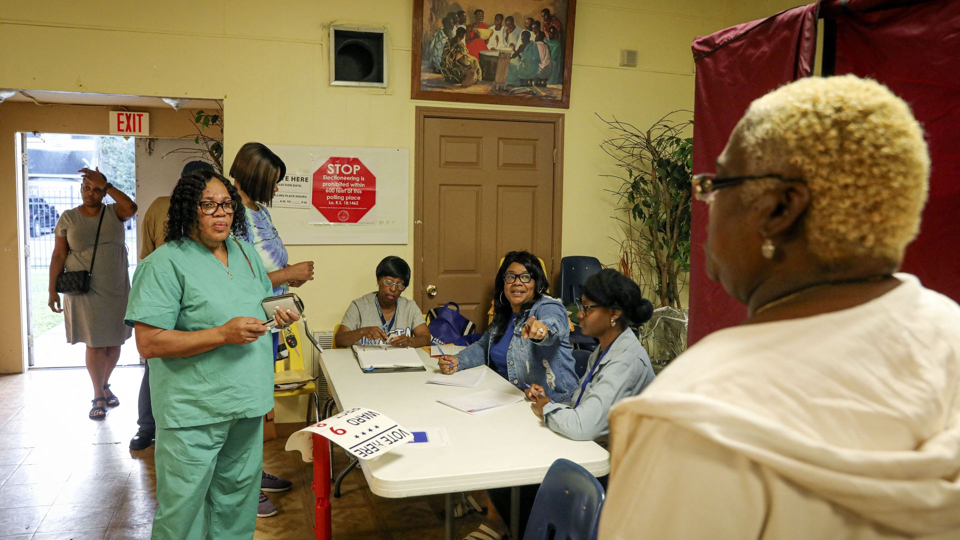 Photo shows people voting in New Orleans.