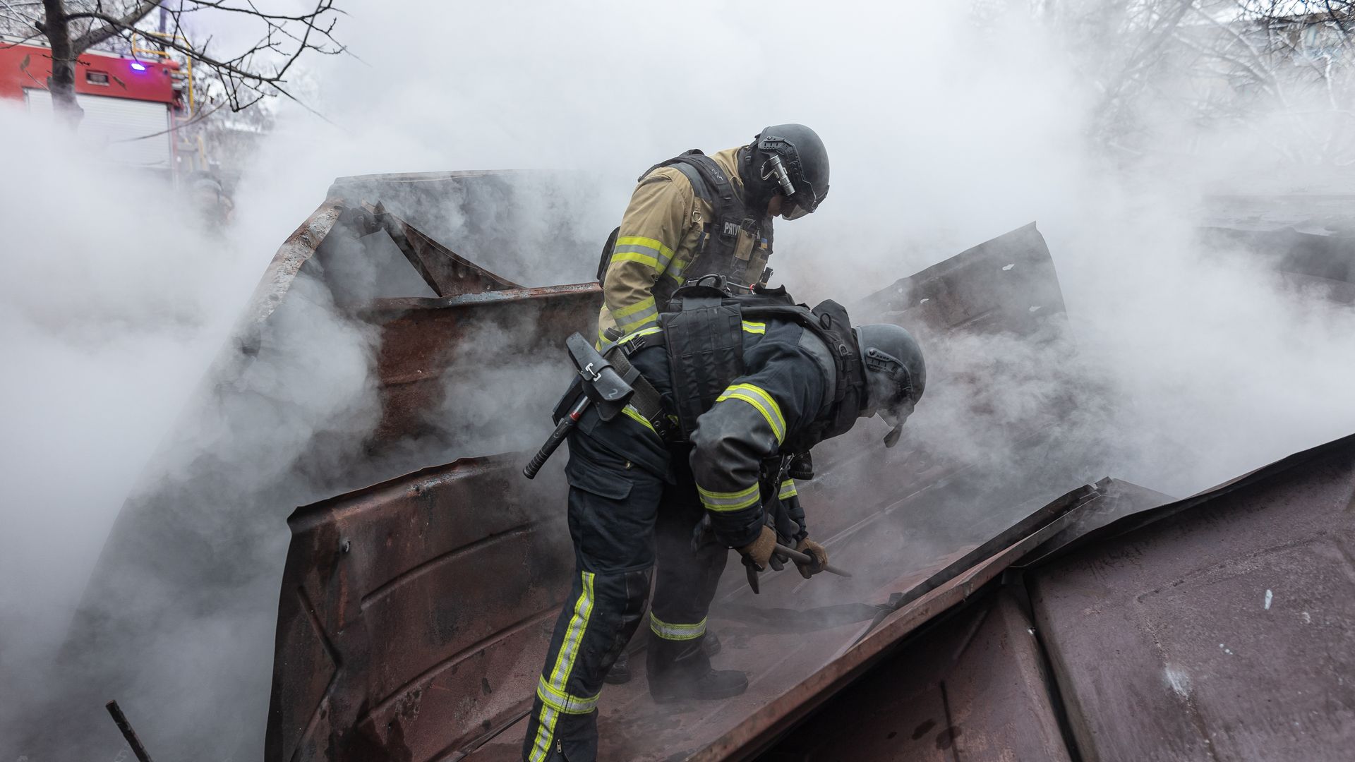 Firefighters try to remove debris following a fire in a garage caused by Russian shelling of the city of Kostiantynivka, Ukraine on December 12, 2024. (Photo by Diego Herrera Carcedo/Anadolu via Getty Images)