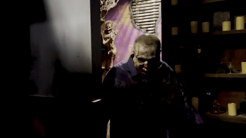 a video of a man dressed up as a dead person looking creepy in a haunted house with blood over him