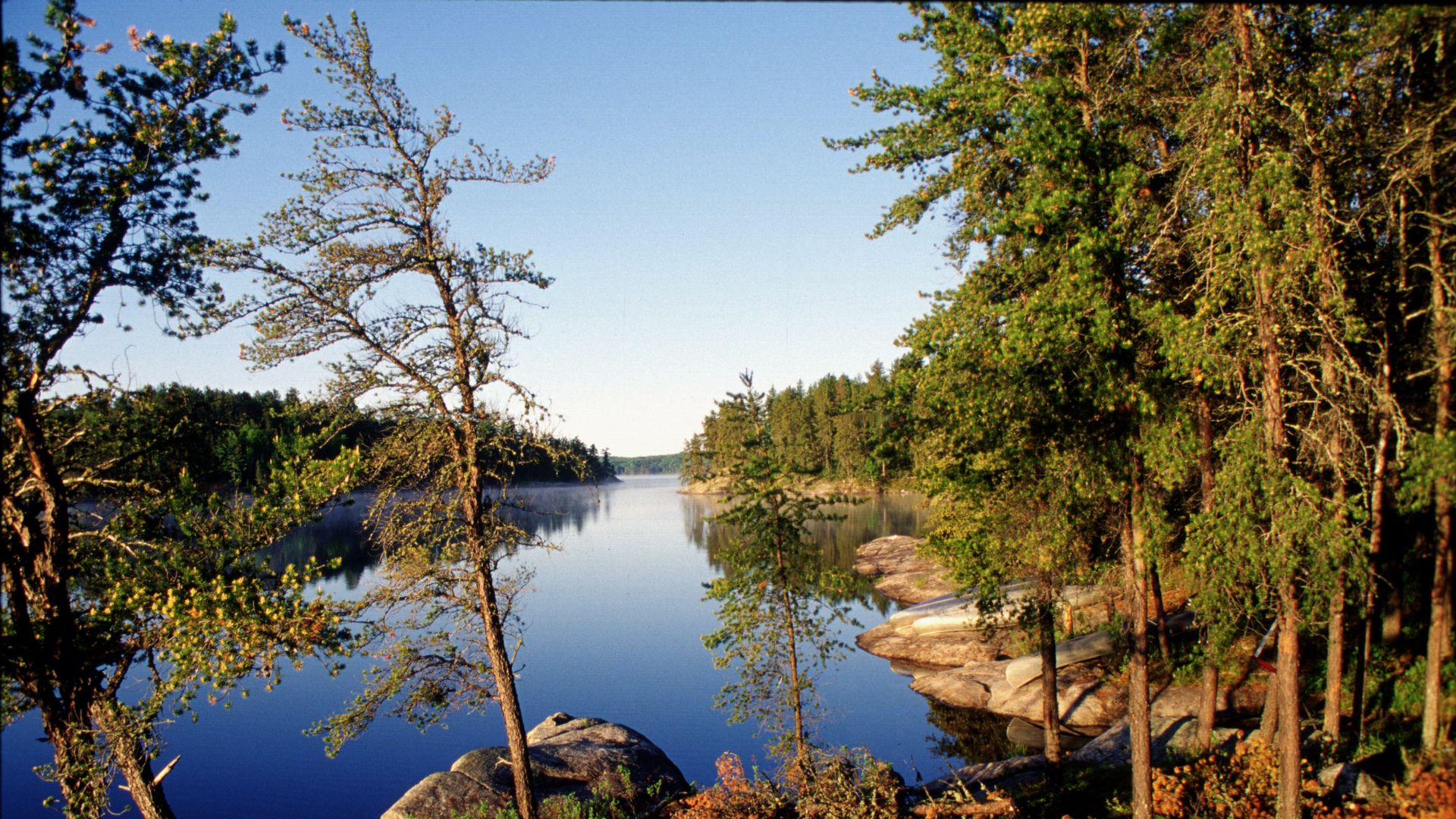 A peaceful lake with trees around it 