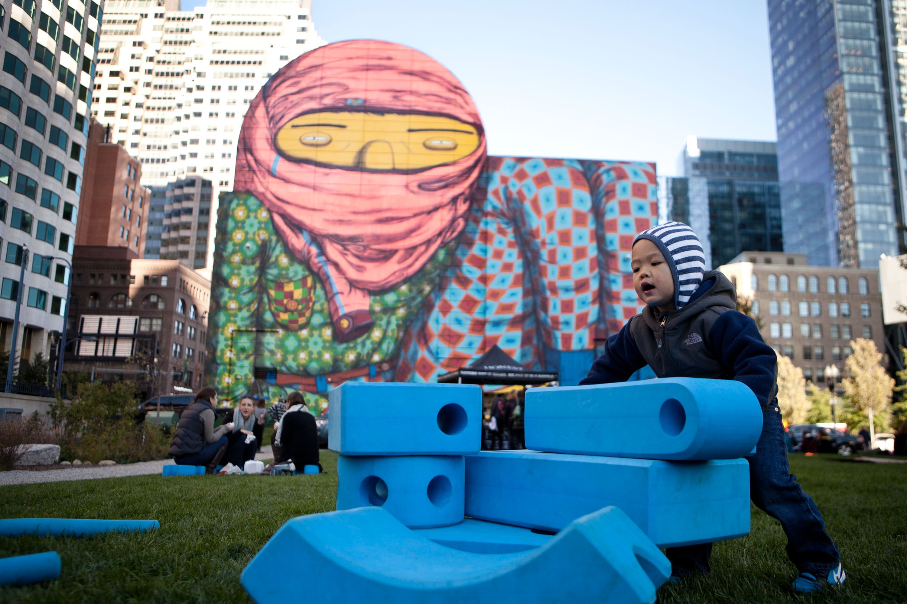 a chgild playing by a mural