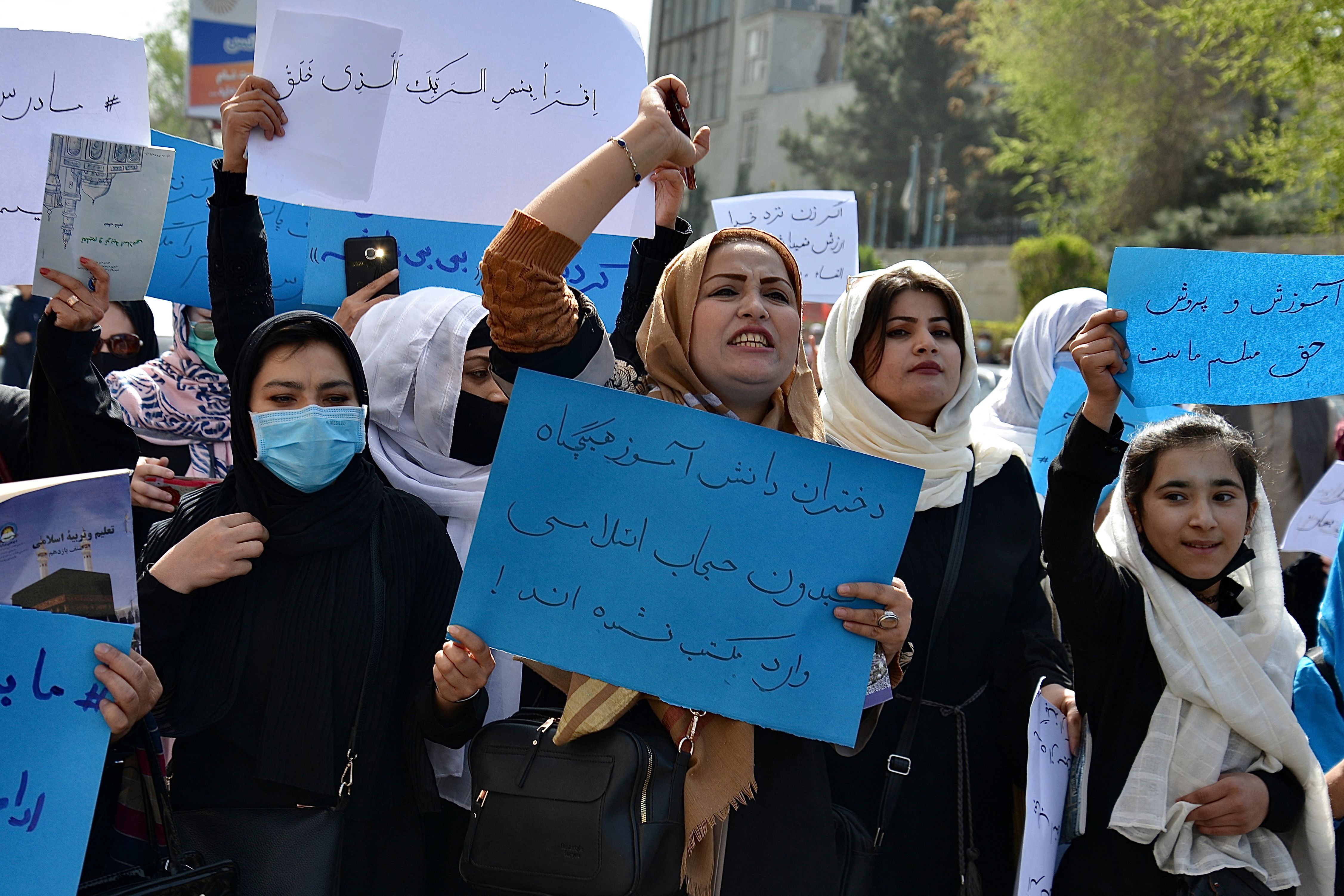 Afghan women and girls take part in a protest in front of the Ministry of Education in Kabul on March 26, 2022