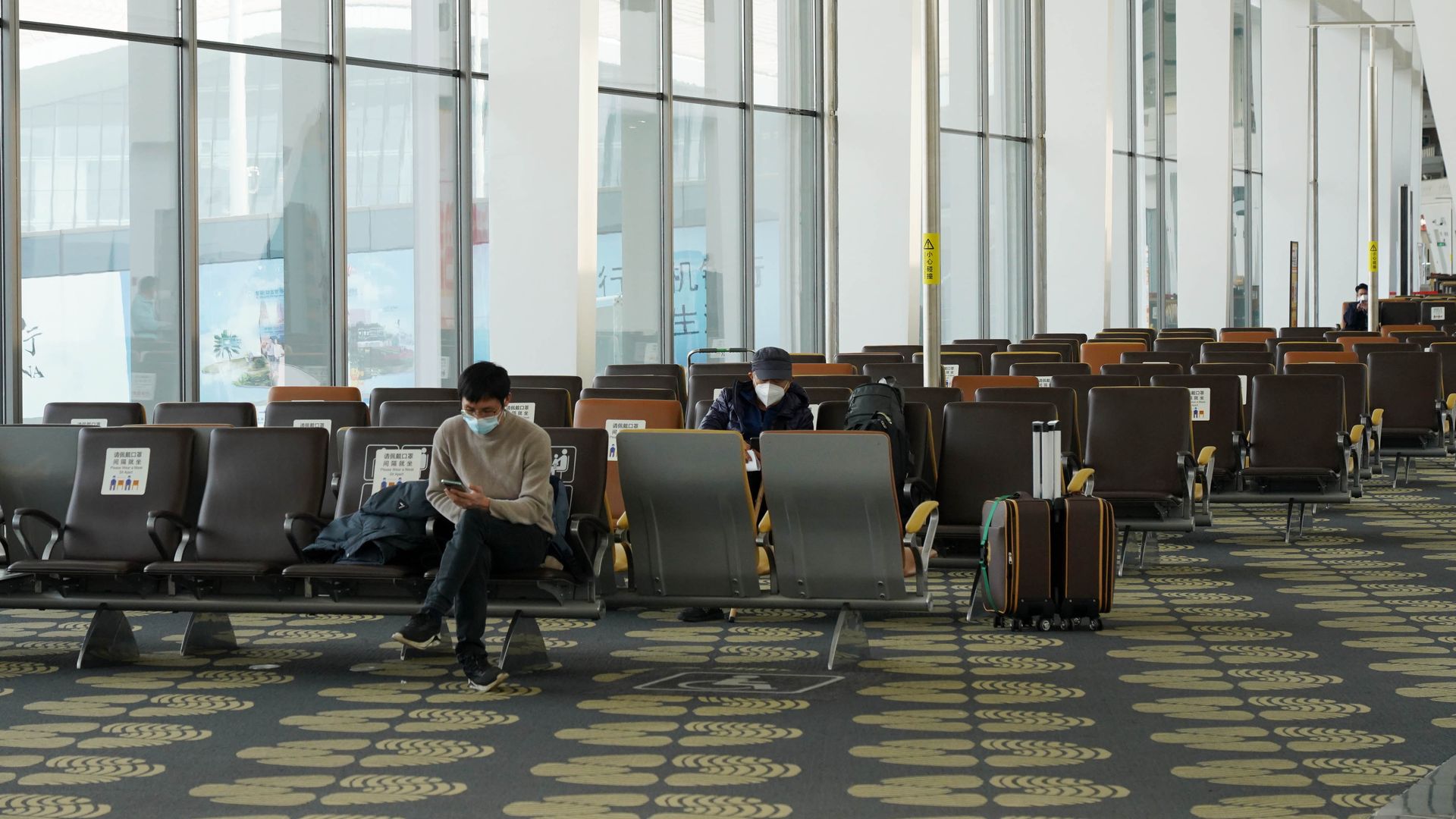 People wearing masks at an airport. 