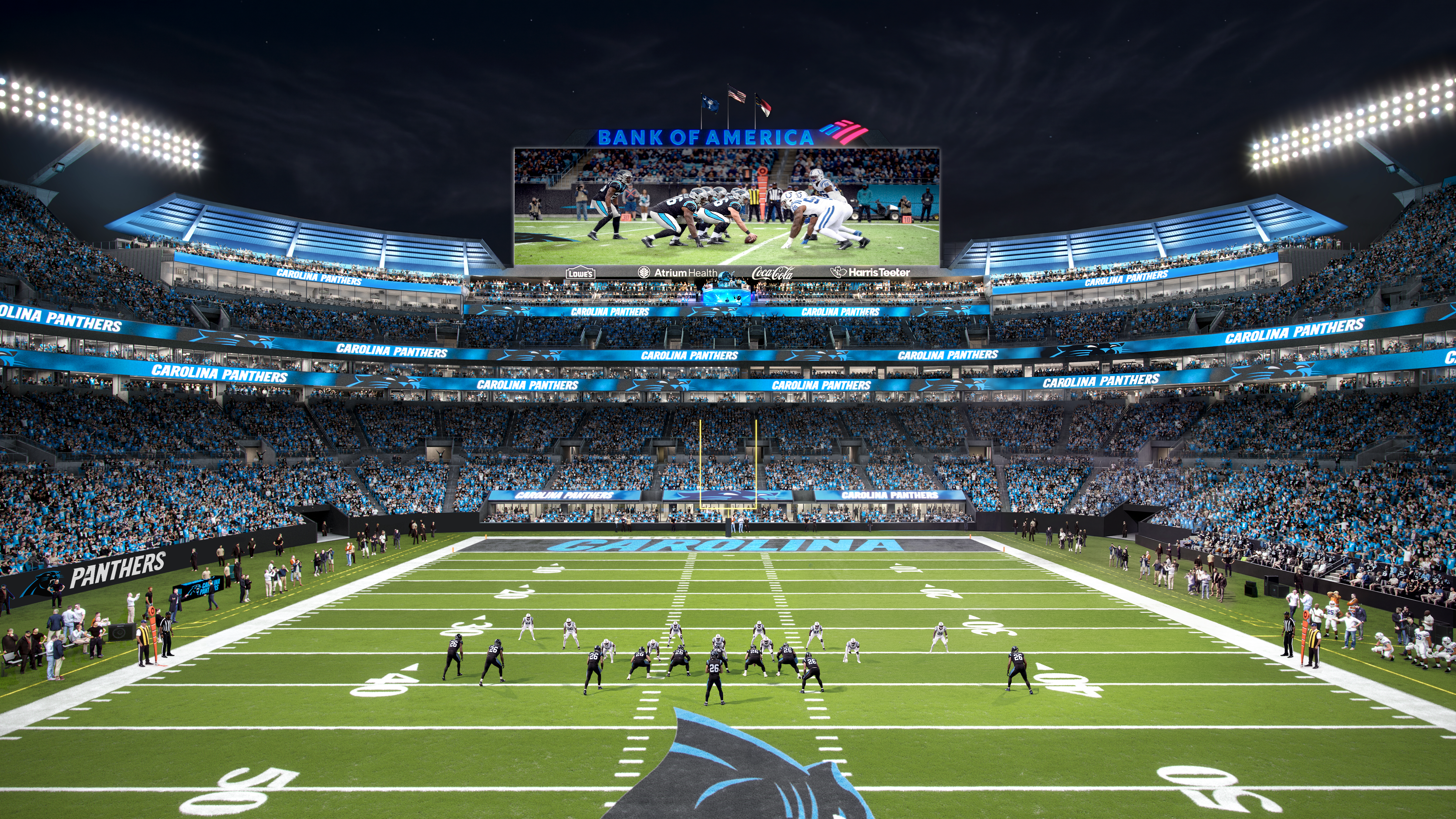 Night stadium packed with blue-clad fans; a large center scoreboard shows a football play beneath a "BANK OF AMERICA" sign. Panthers banners line the stands and the end zone bears the Panthers logo.