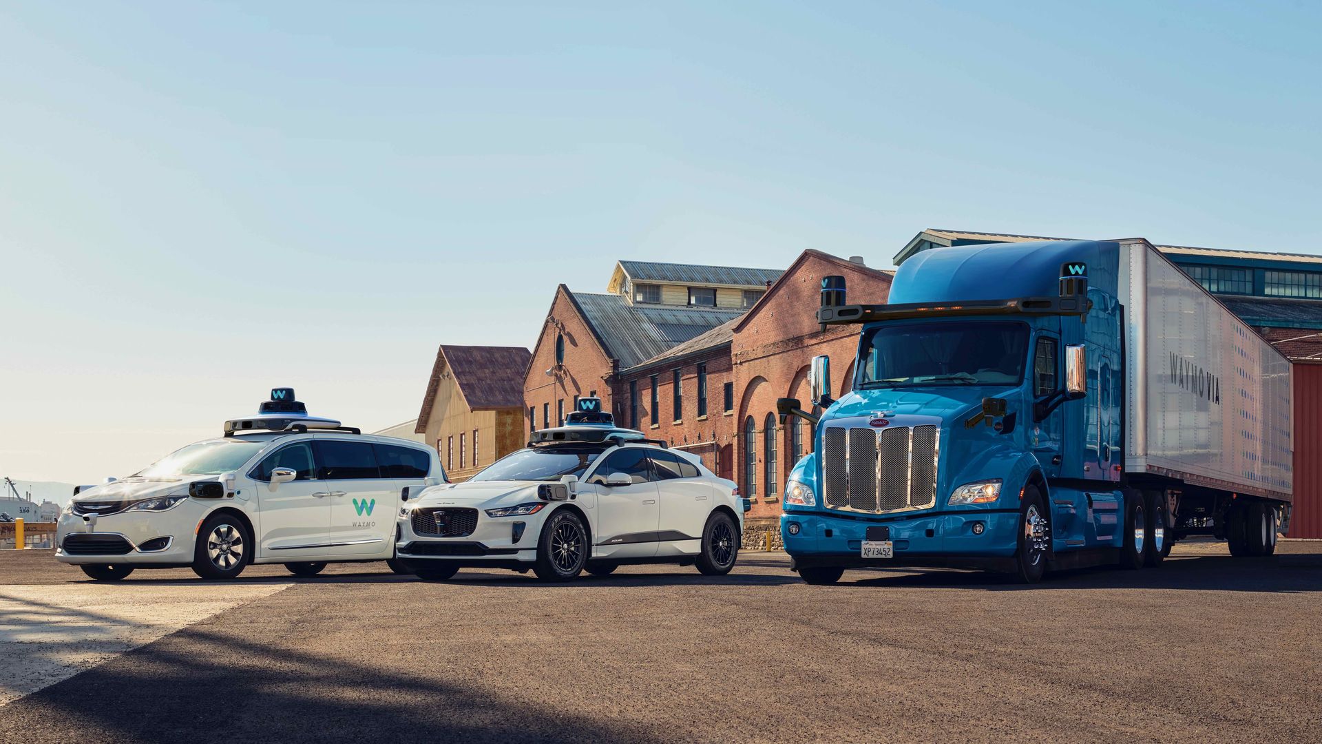 Image of Waymo's self-driving lineup, including a Pacifica minivan, Jaguar iPace and semi-truck.
