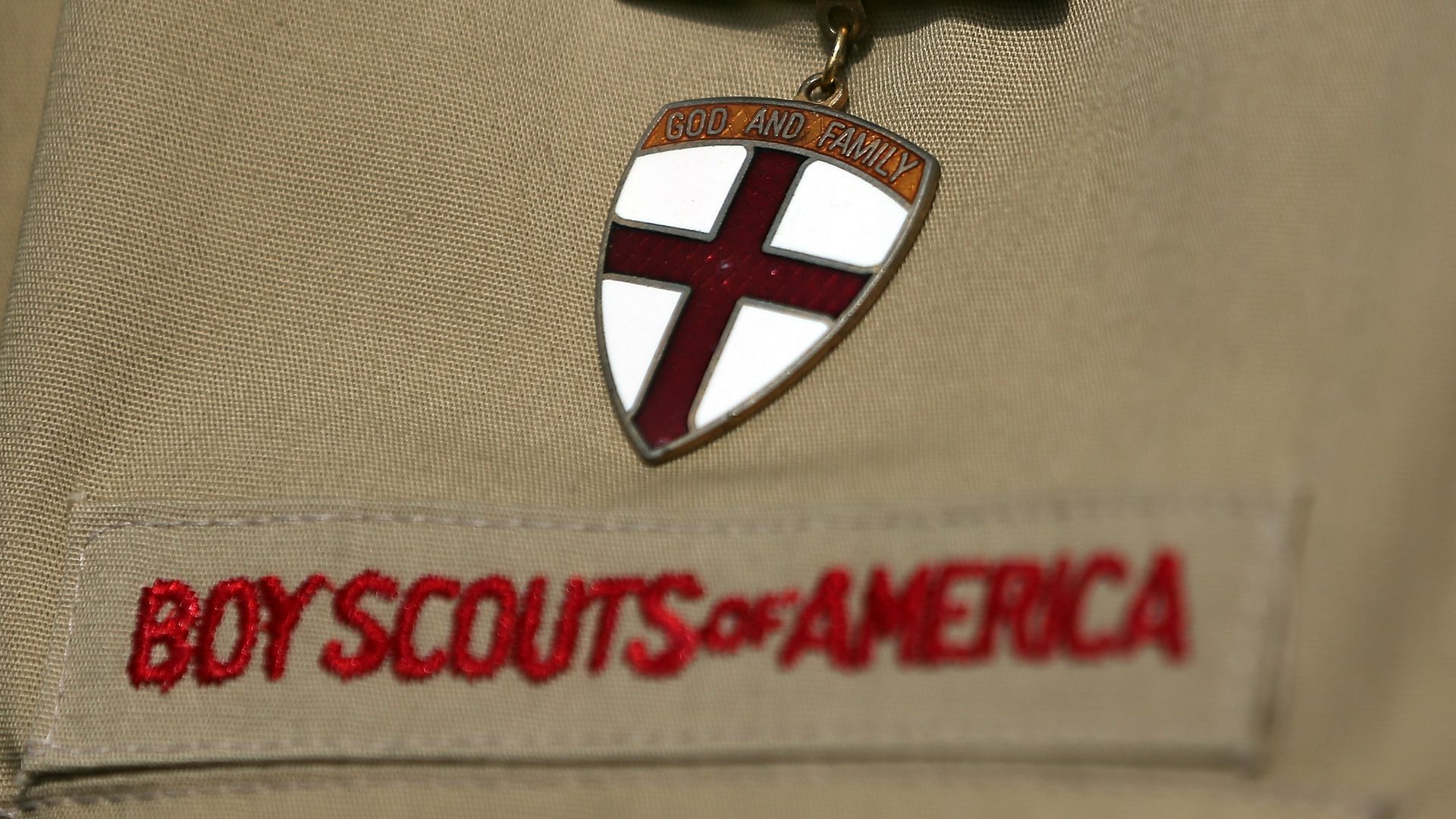 Photo of a Boy Scouts of America uniform with a pin saying "God and Country"