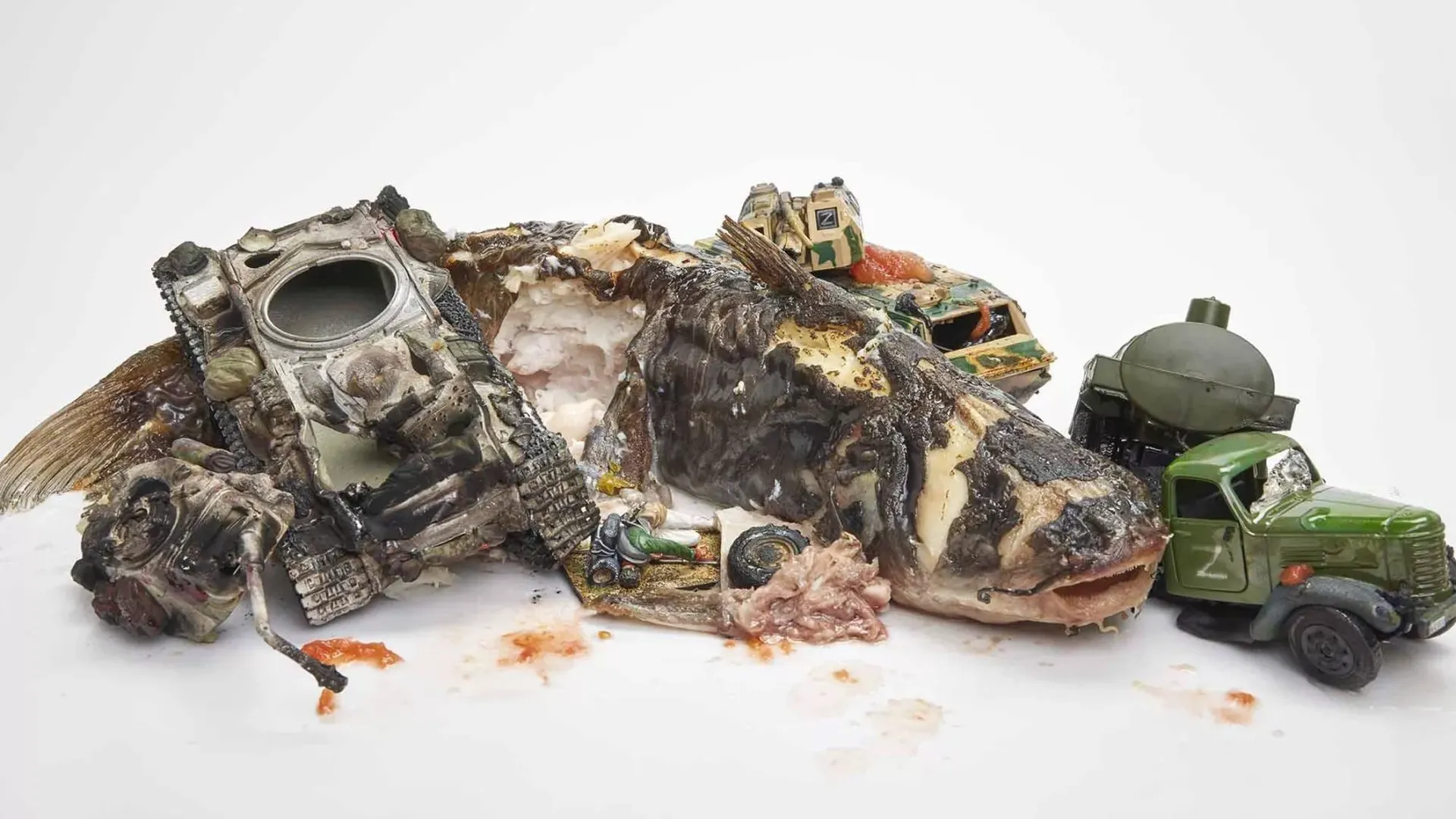Jim Riswold's "Putin's Big Parade With Dead Catfish" with toy tanks and real dead fish