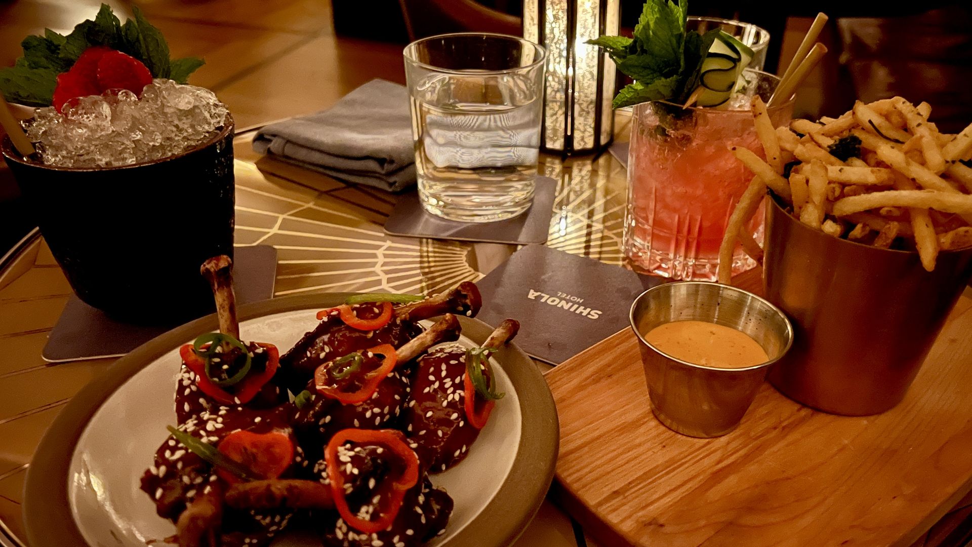 The spread at Evening Bar: Sticky Teriyaki wings and fries. Photo: Samuel Robinson/Axios
