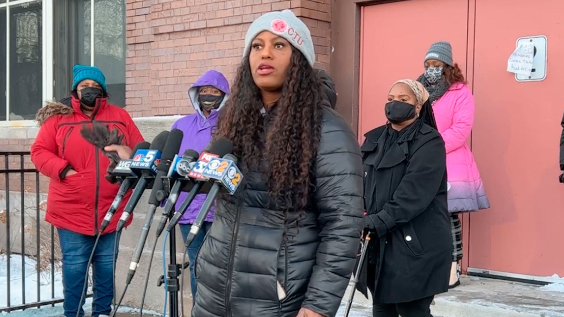 Woman at a podium with lots of microphones.