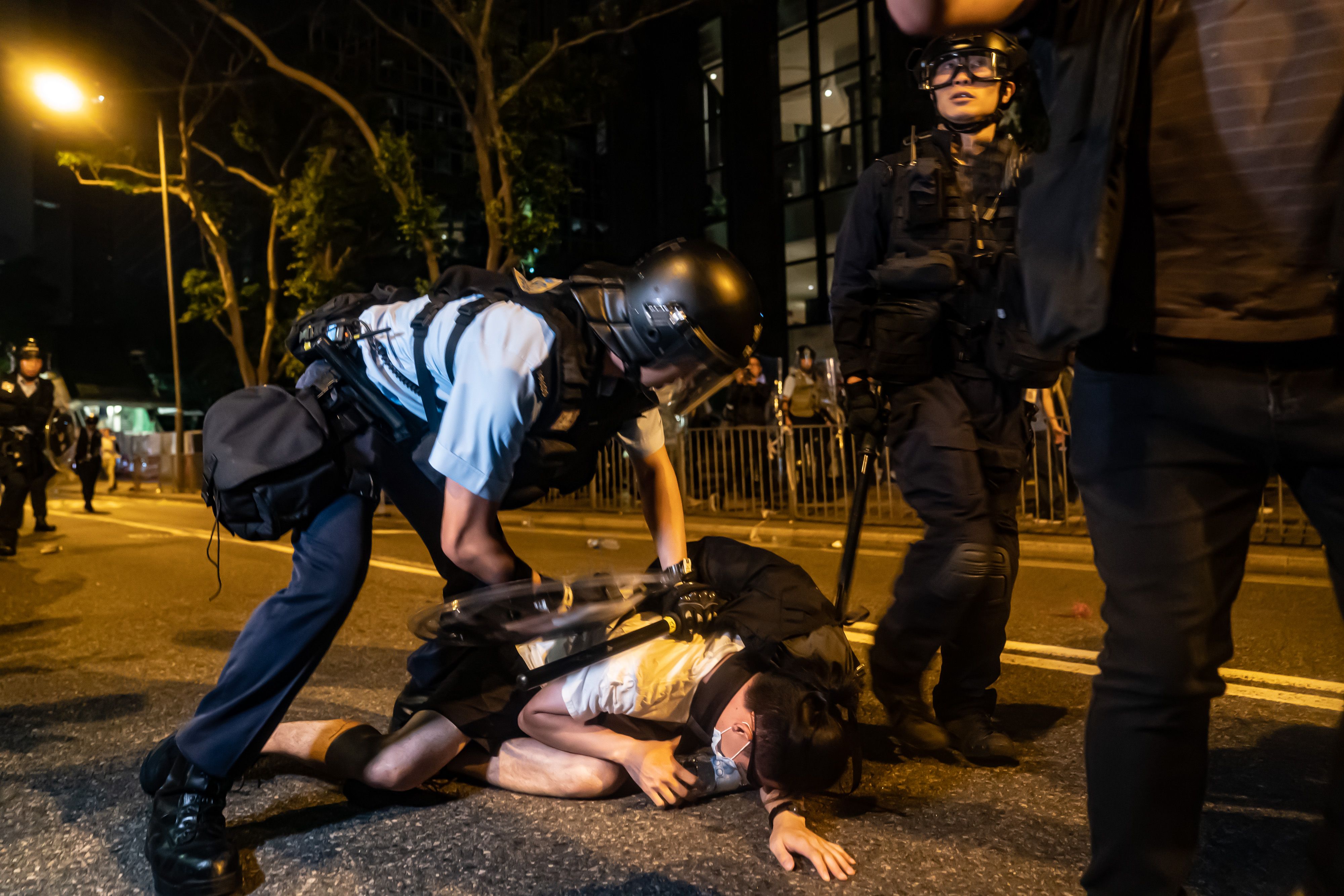 A protester is detained during a clash after a rally against the extradition law proposal at the Central Government Complex on June 10, 2019.