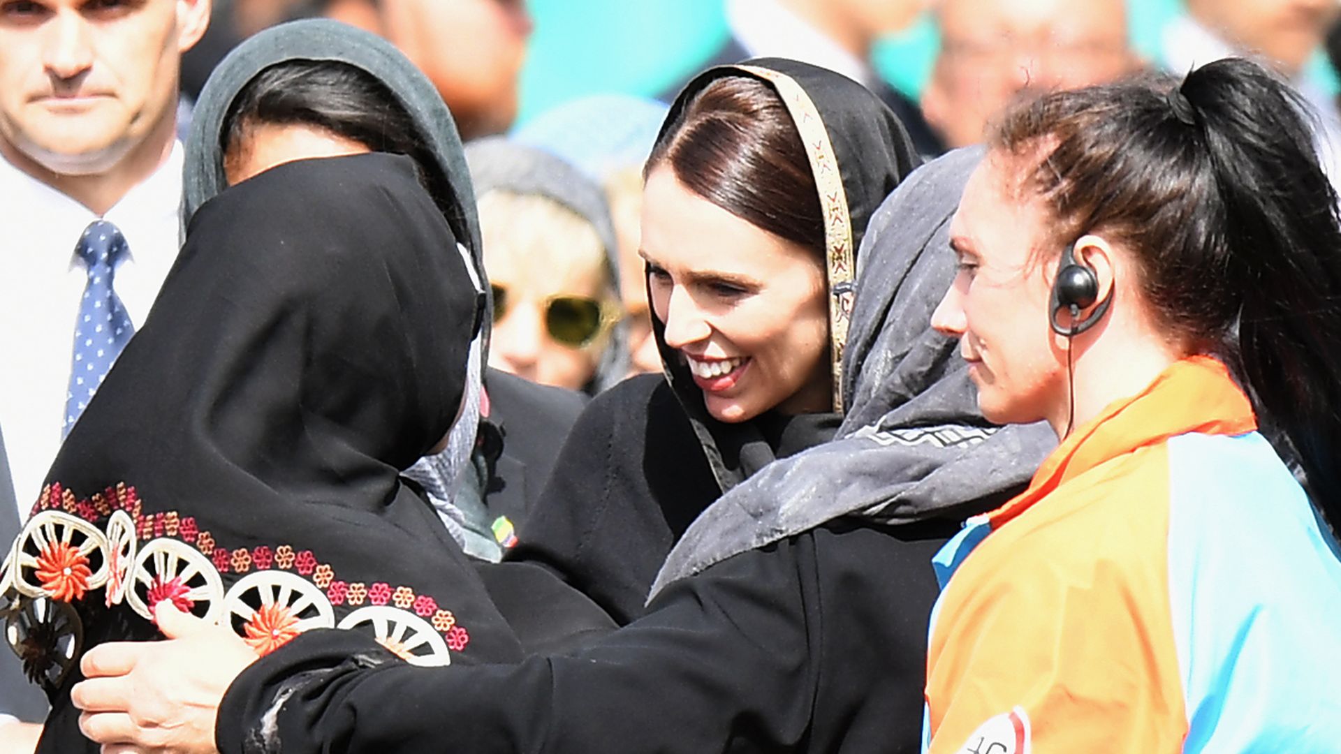 New Zealand Prime Minister Jacinda Ardern hugs a woman during the country's day of reflection for attack victims.
