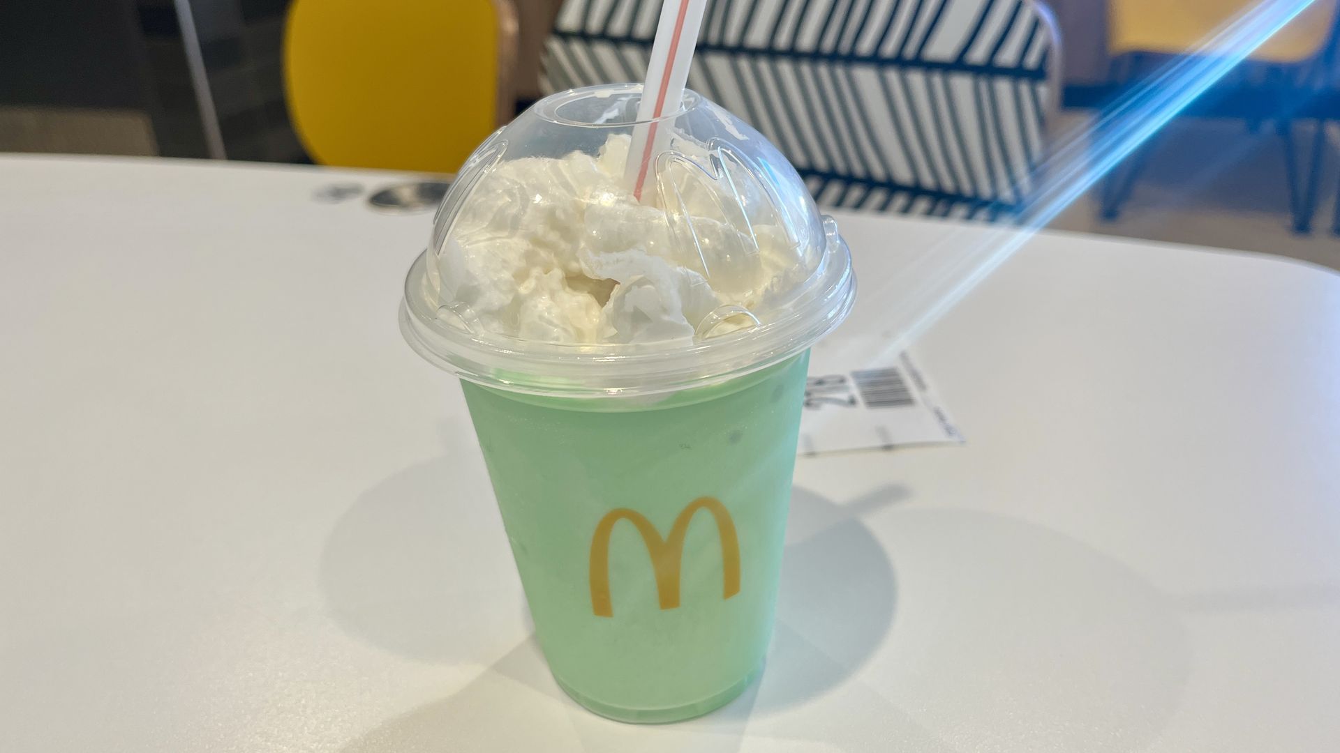 McDonald's Shamrock Shake with whipped cream and a straw.