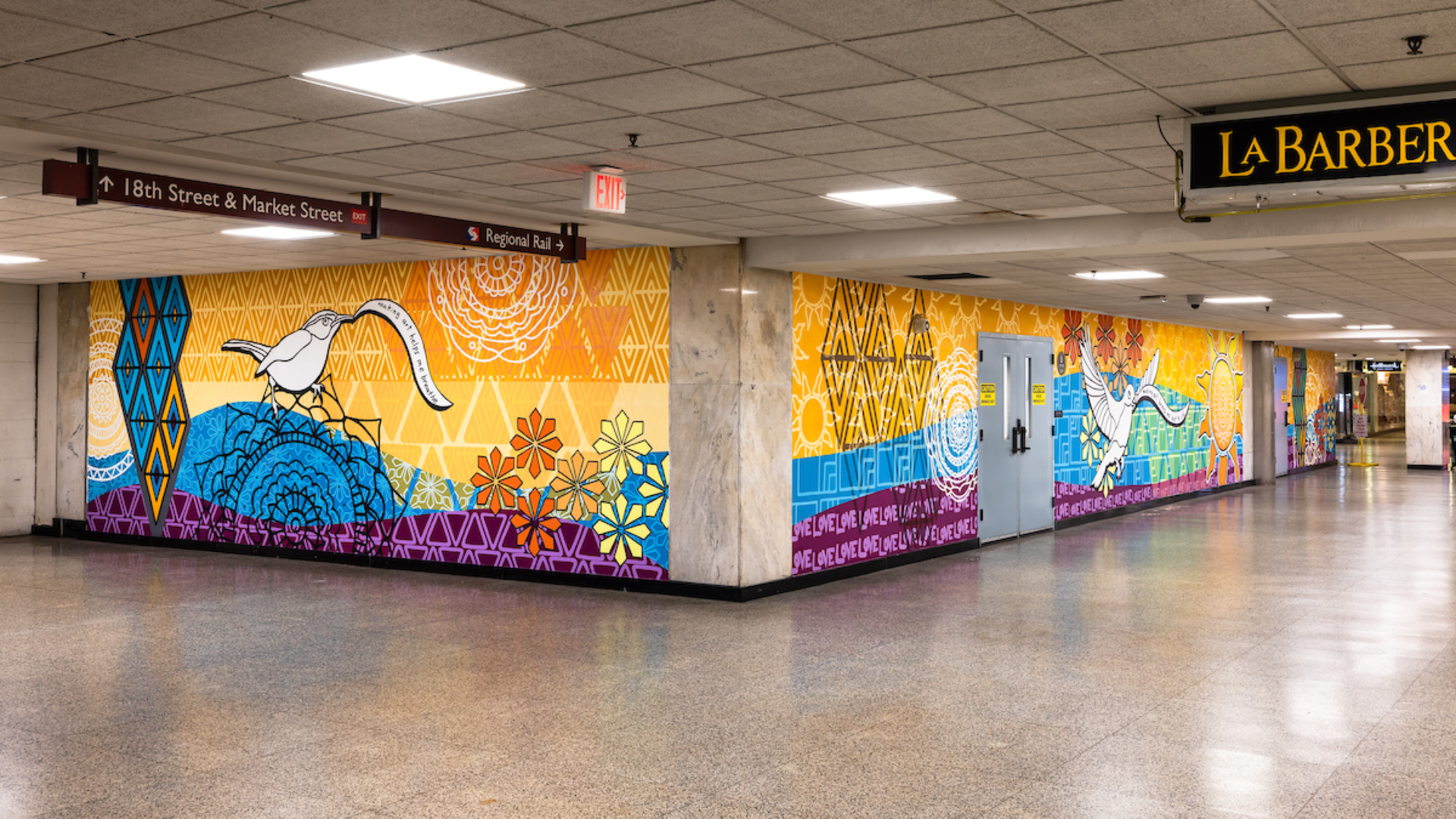 A bird holding a strip of paper that says "making art helps me breathe" is featured prominently in artist Lisa Kelley's new mural inside Philadelphia's Suburban Station.