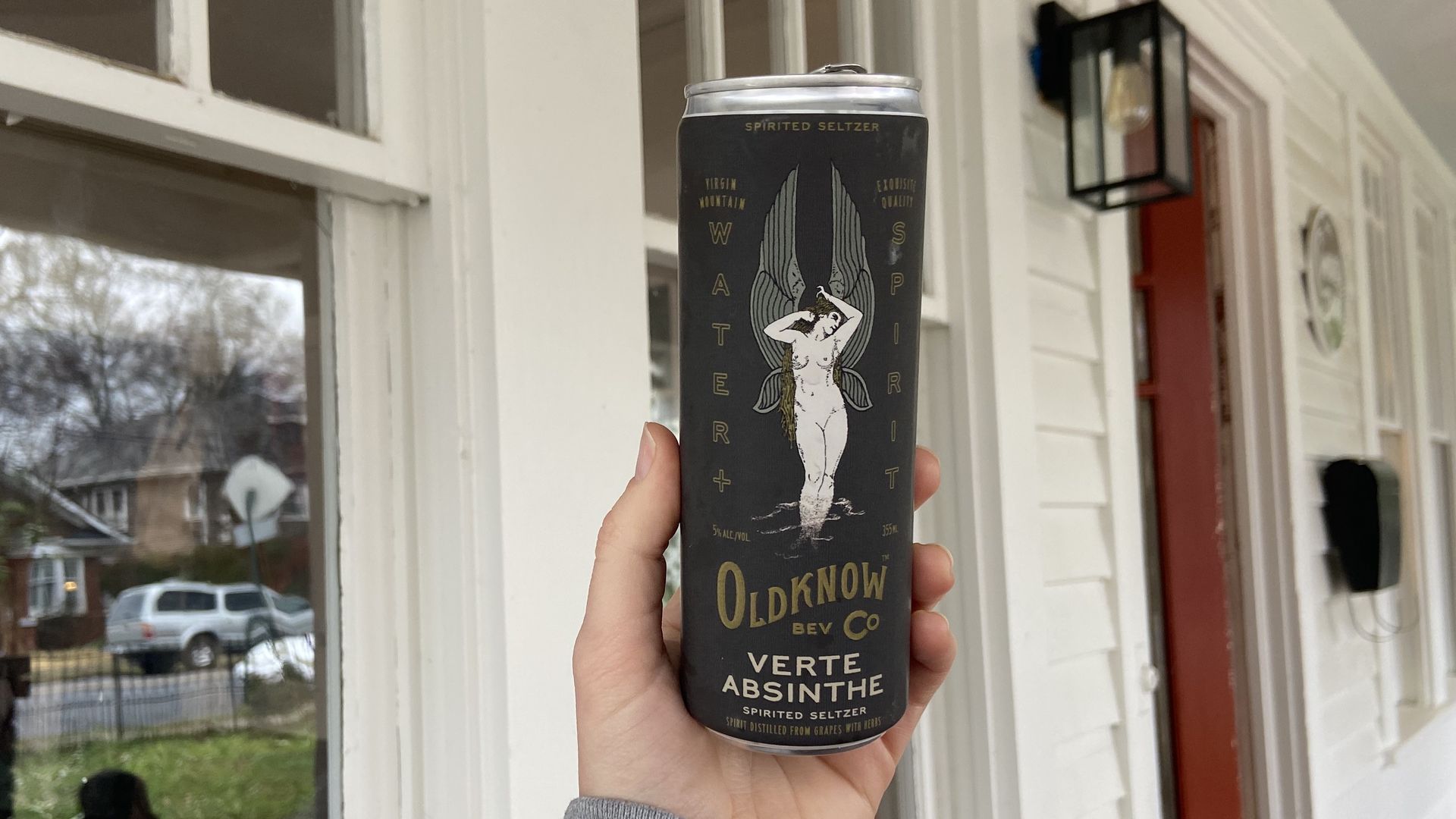 Hand holding absinthe seltzer can