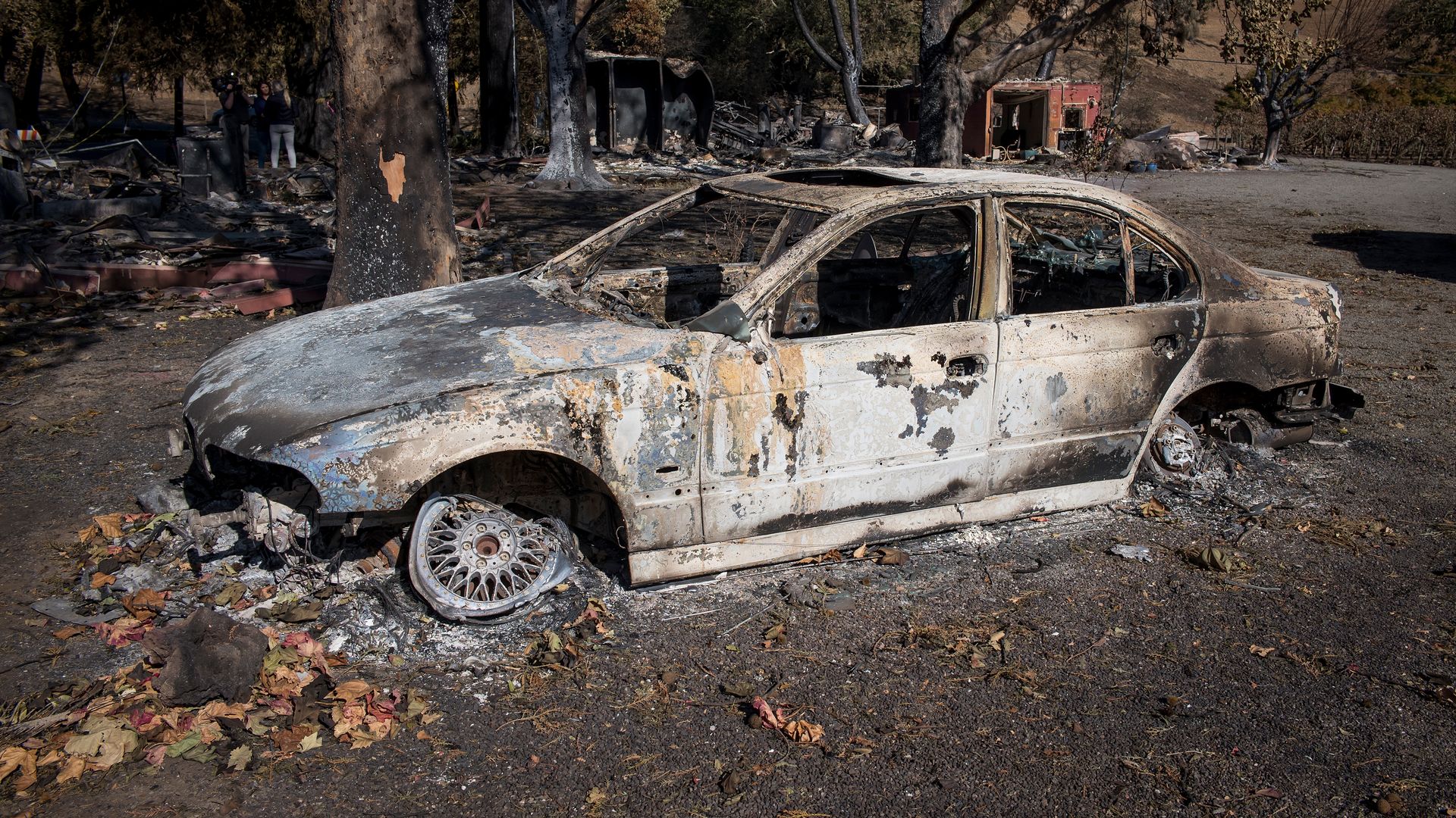 A vehicle burned out by the Kincade Fire sits at the Garden Creek Vineyards in Geyserville, California,
