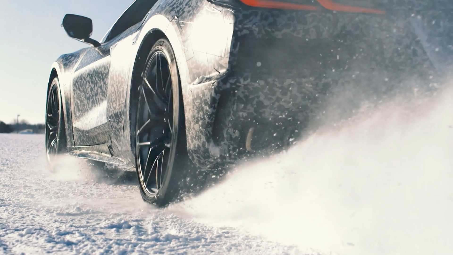A sports car accelerates in the snow