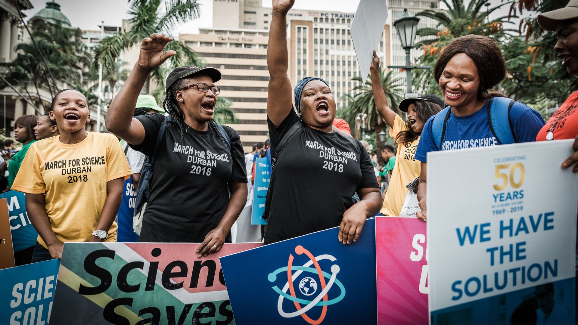People holding banners shout slogans during the 'March for Science' in Durban