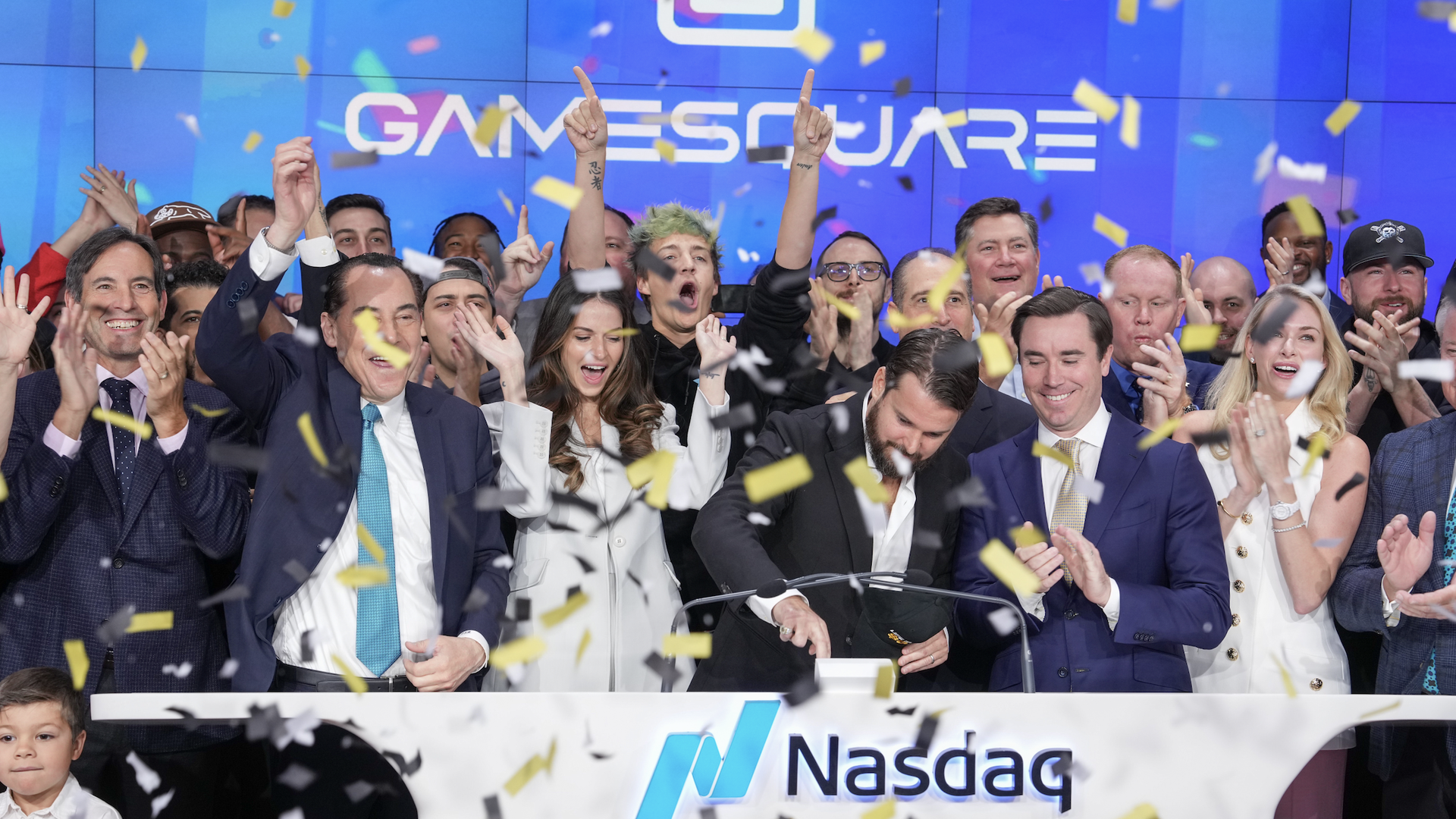 GameSquare executives ringing the bell at the Nasdaq, yellow confetti falling