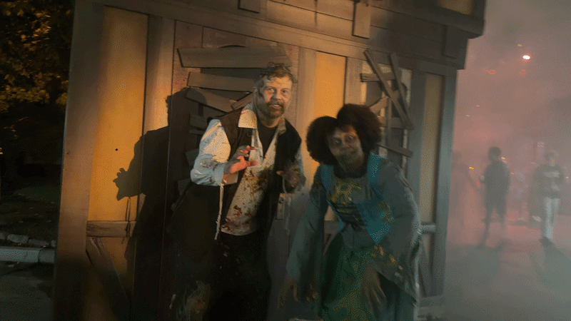Casey and Swilley dressed as doomed villagers do their best zombie impression outside the Pumpkin Eater scare zone.