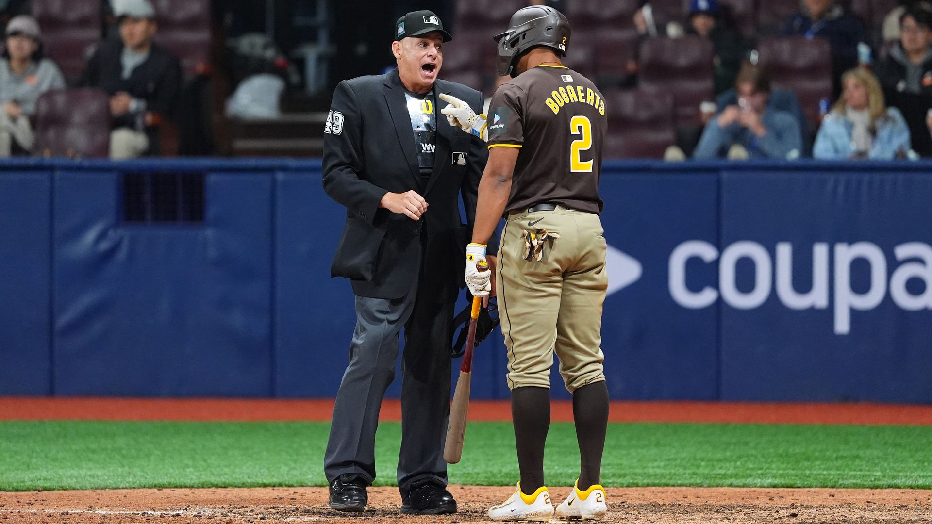 San Diego Padres player Xander Bogaerts points his finger while arguing with an umpire at home plate. 