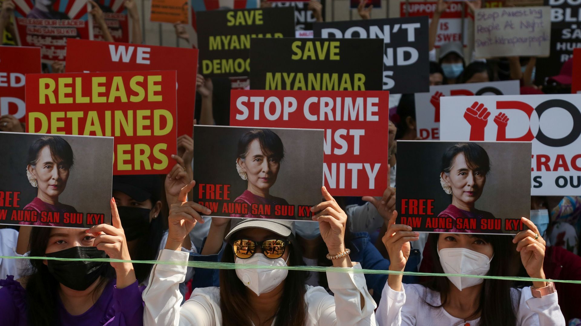 Protesters hold up signs calling for the release of detained Myanmar civilian leader Aung San Suu Kyi 