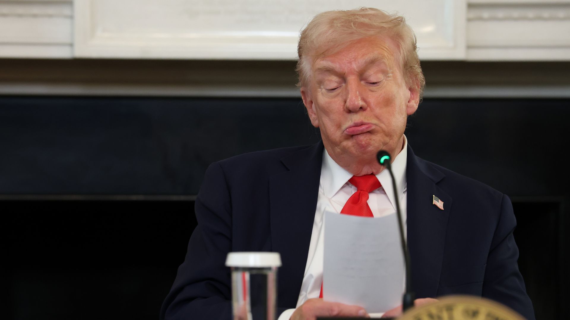Trump reads a note