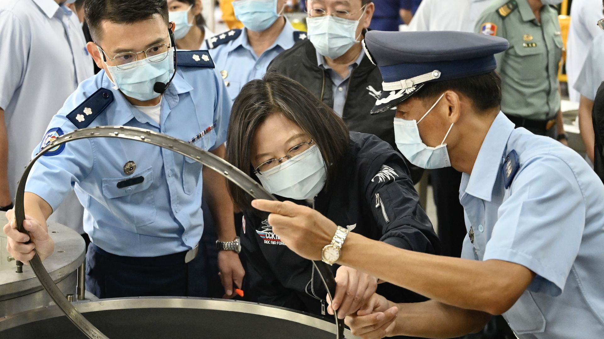Taiwan President Tsai Ing-wen (C) visits a turboprop engine factory at a military base in Kaohsiung on September 26, 2020.