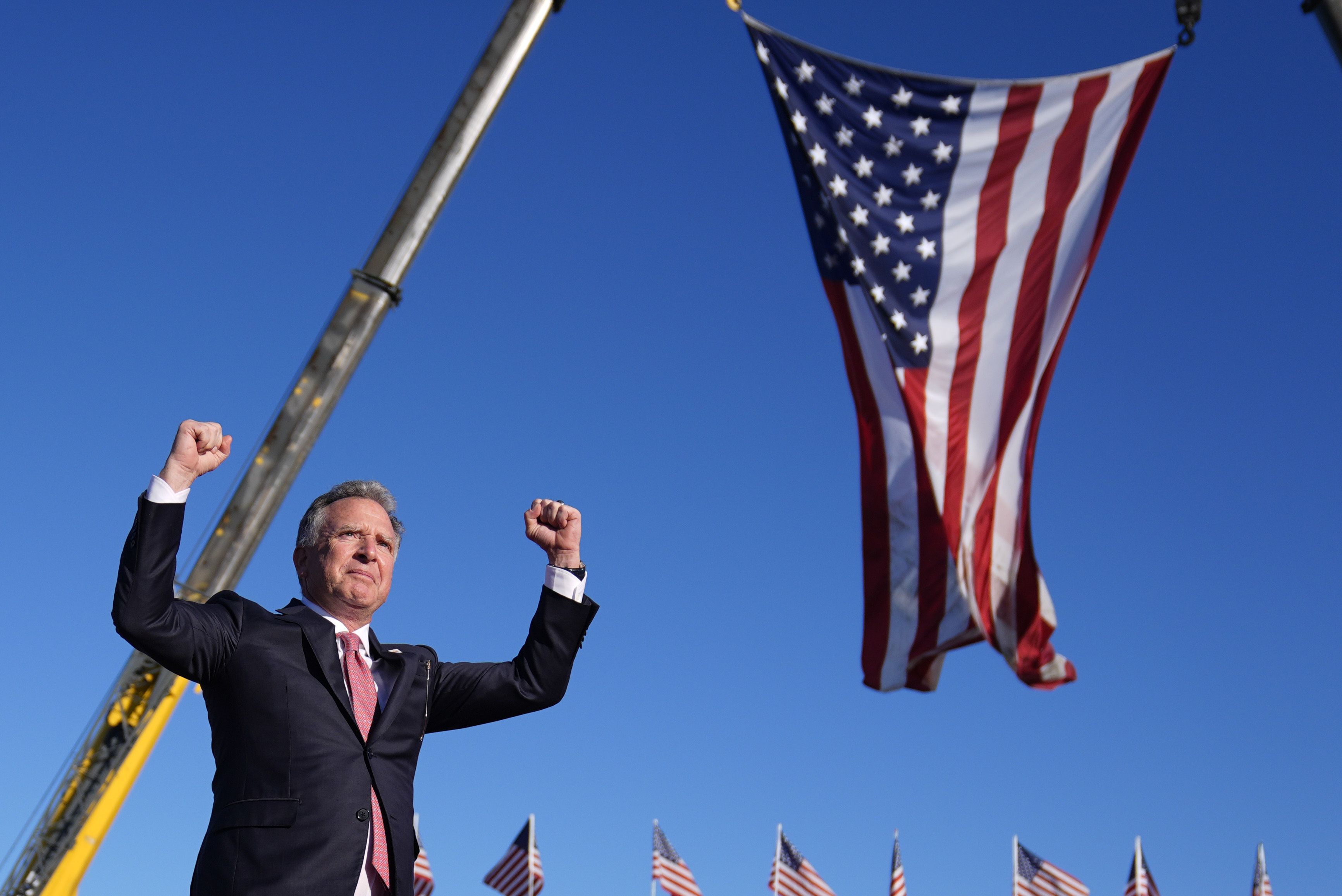 Witkoff in front of a U.S. flag