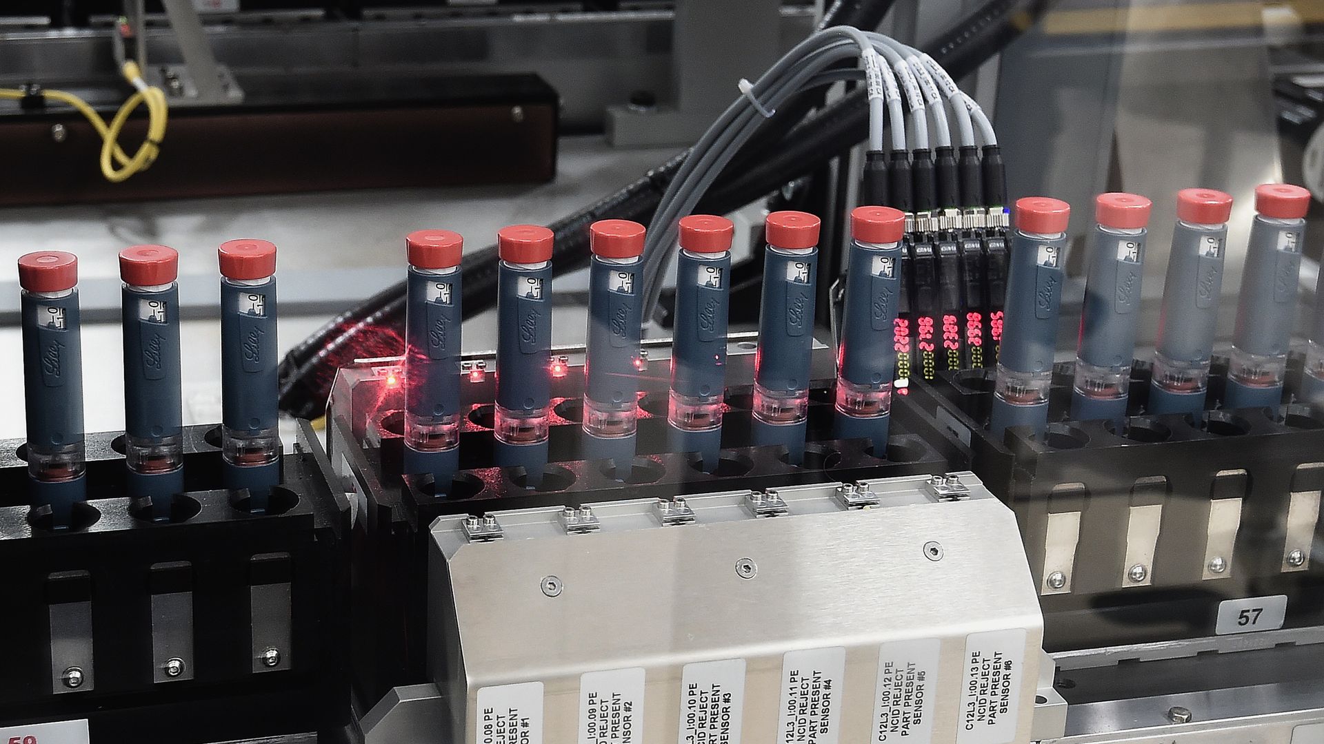 Vials of insulin on an assembly line