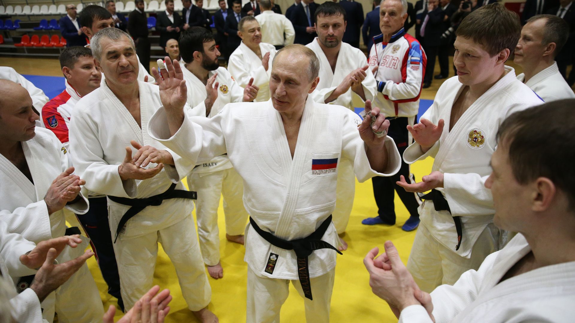 Putin surrounded by judo athletes