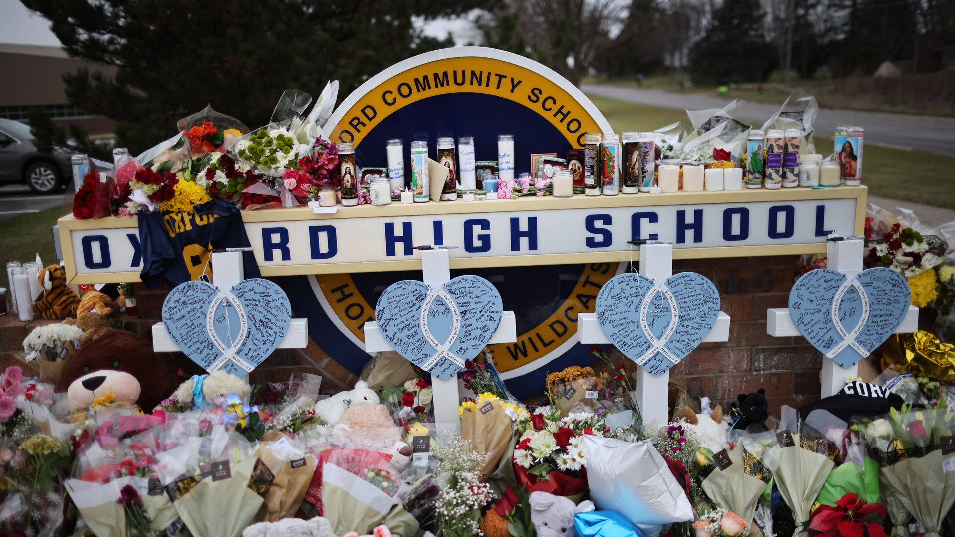 Picture of Oxford High School sign covered with flowers