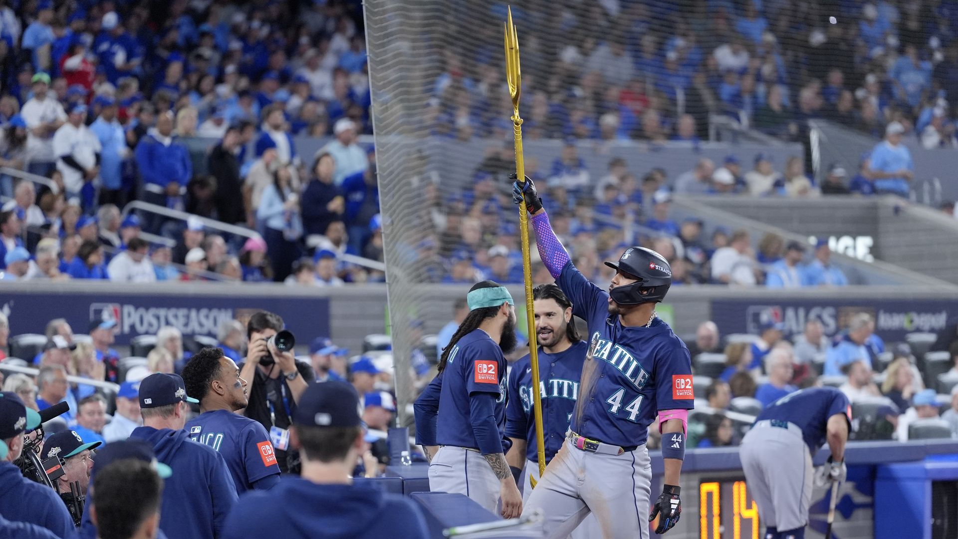 A Mariners' player holds up the golden neptune before a game. 