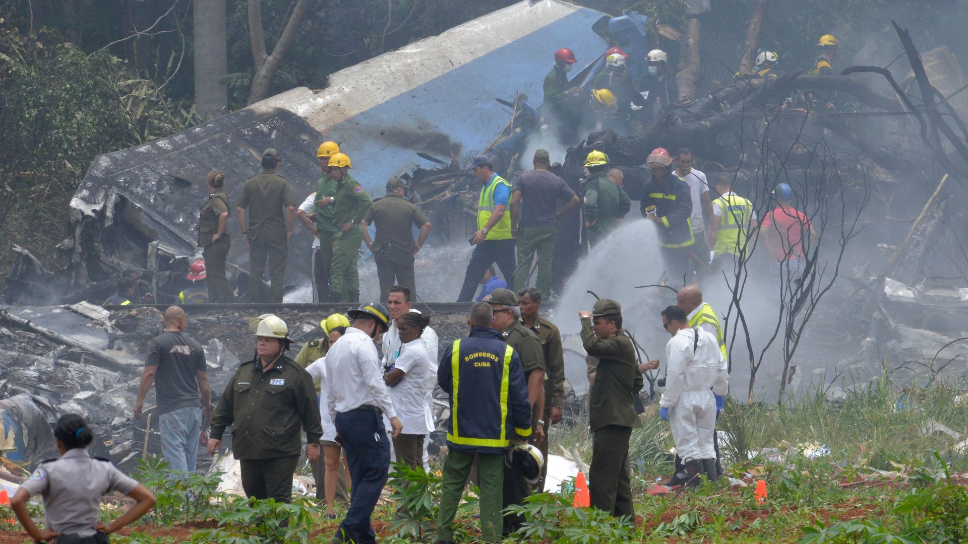 Rescue workers arrive to the scene of the plane crash close to the Havana Airport, in Cuba