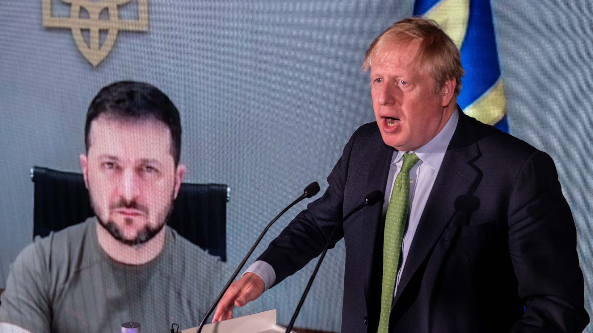 Boris Johnson speaks in front of a live video feed showing Ukrainian President Volodymyr Zelenskyy 
